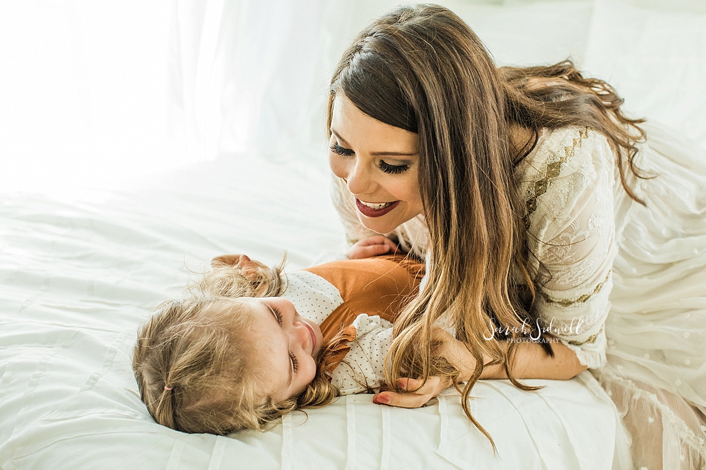 A mom laughs with her daughter  | Sarah Sidwell Photography | Newborn Love