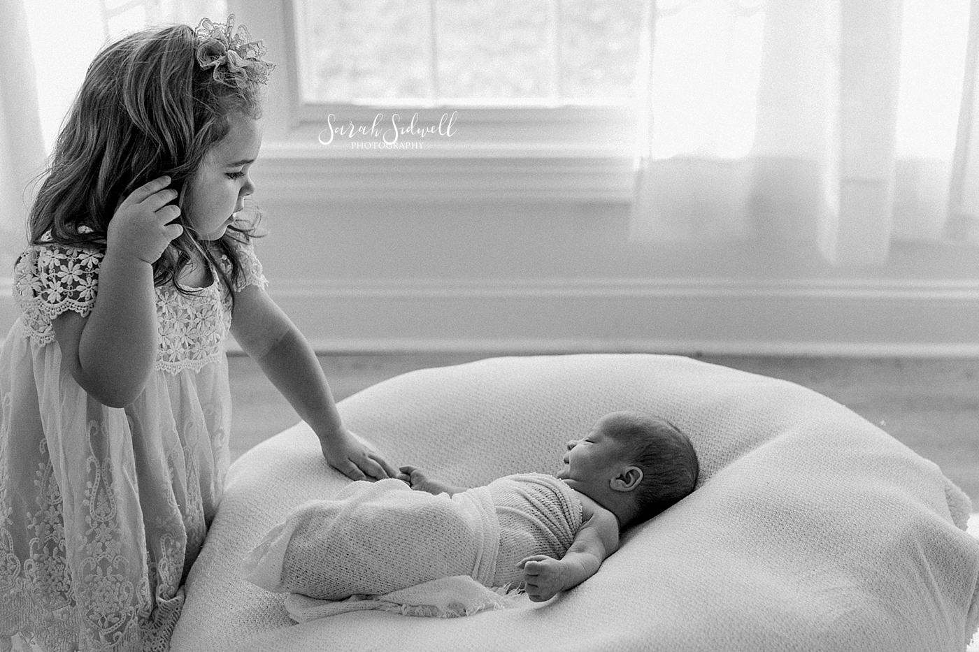 A little girl checks on her newborn brother  | Sarah Sidwell Photography | Newborn Love