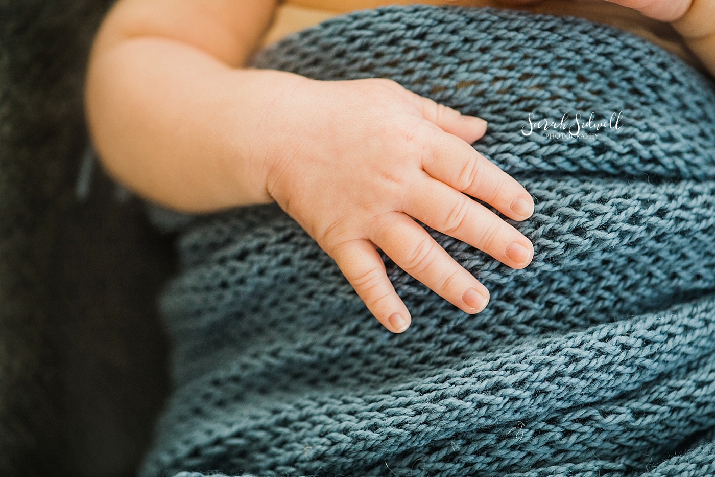 A baby's fingers rest on his tummy  | Sarah Sidwell Photography | Newborn Love