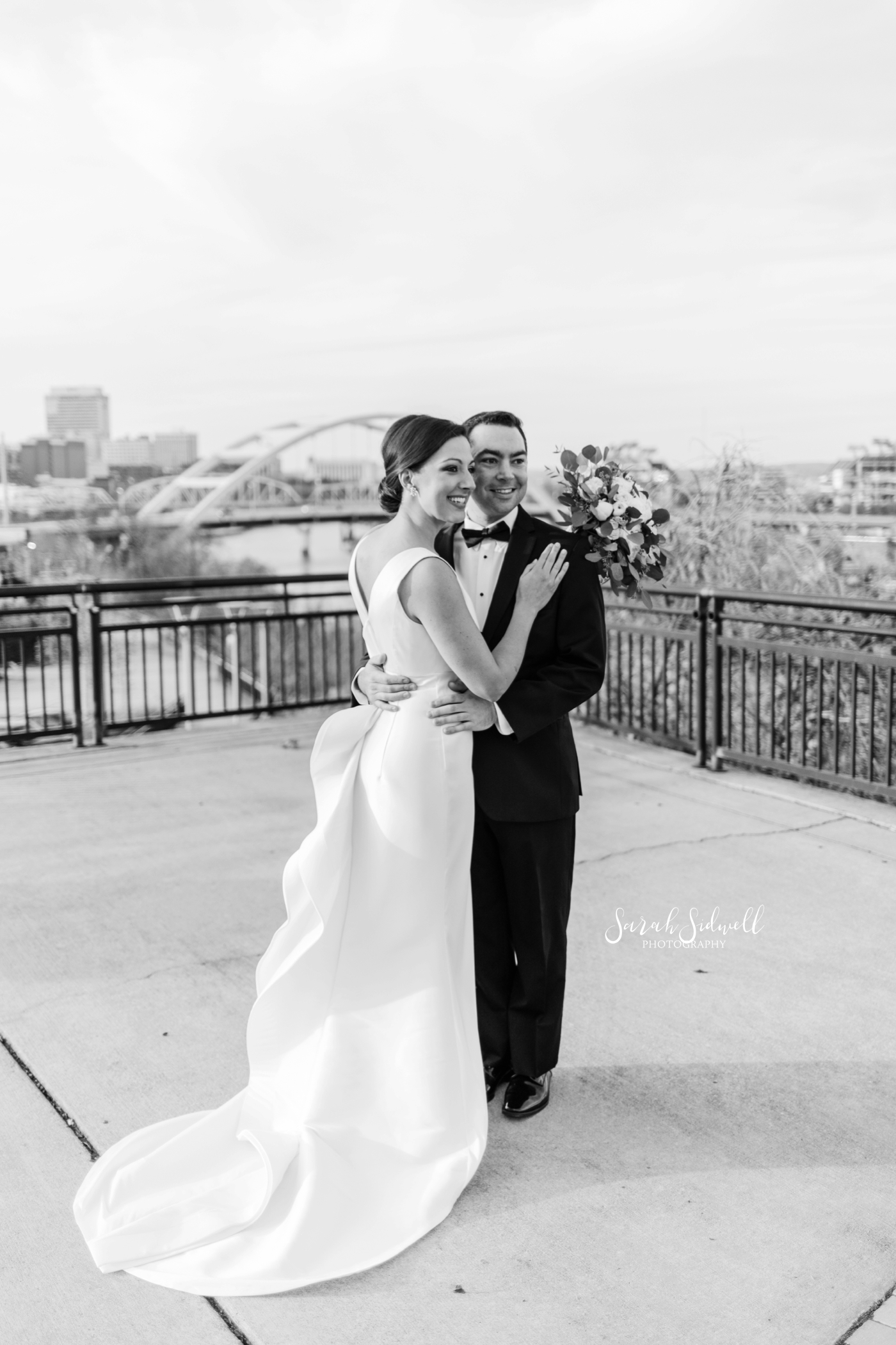 A man hugs his new wife | Sarah Sidwell Photography | The Bell Tower