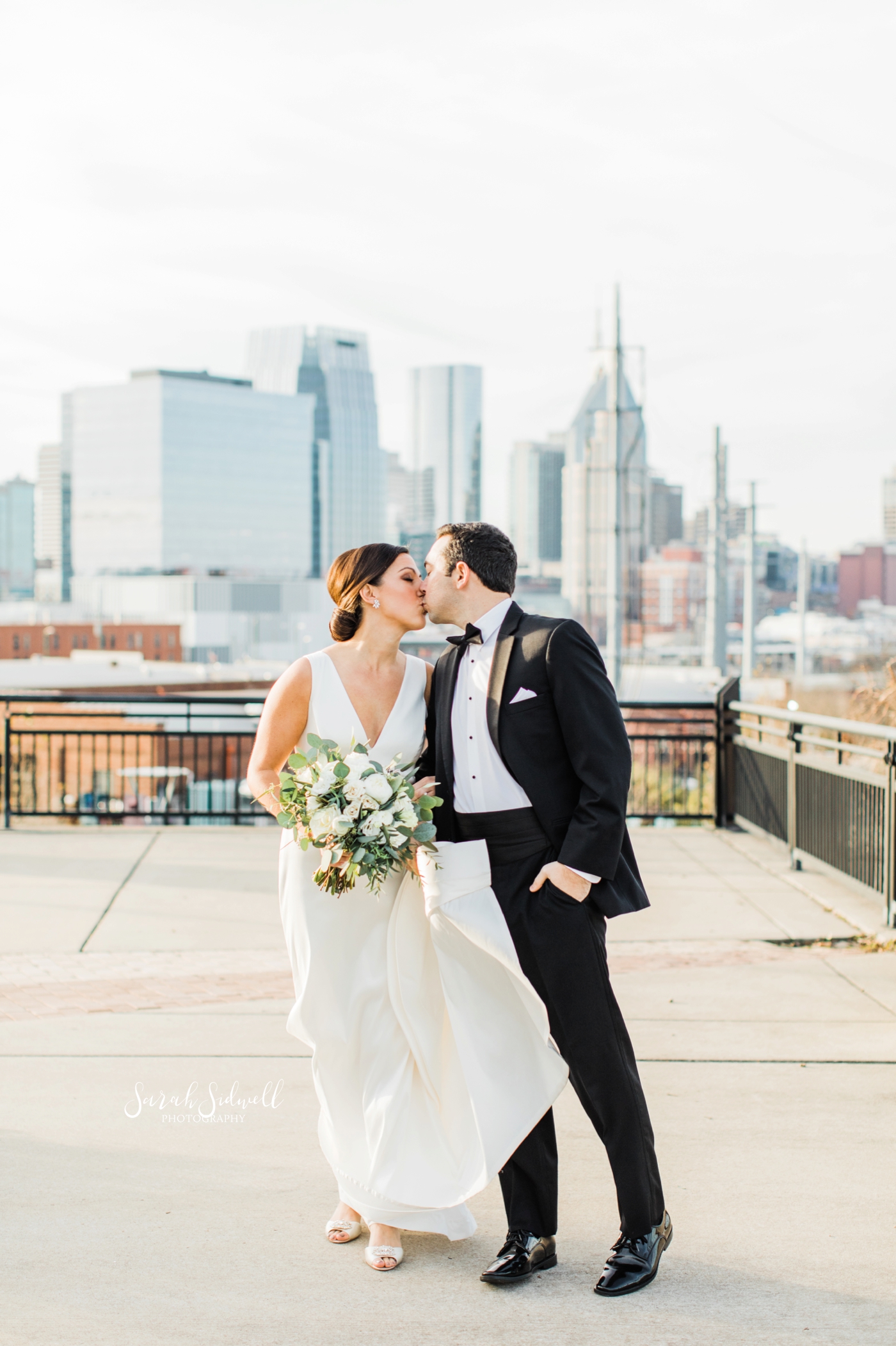 A man gives his bride a kiss | Sarah Sidwell Photography | The Bell Tower