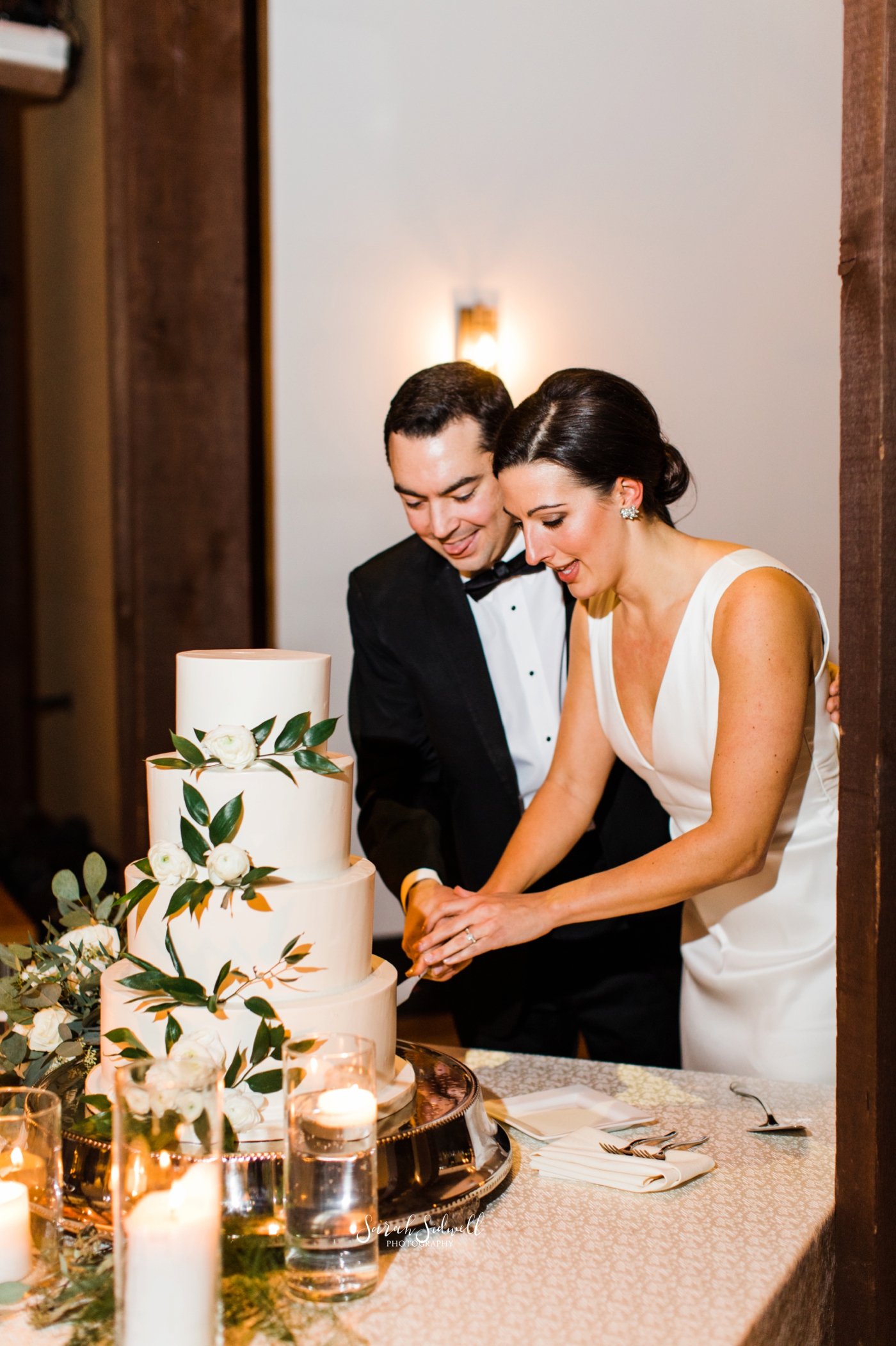 A bride and groom cut their wedding cake | Sarah Sidwell Photography | The Bell Tower