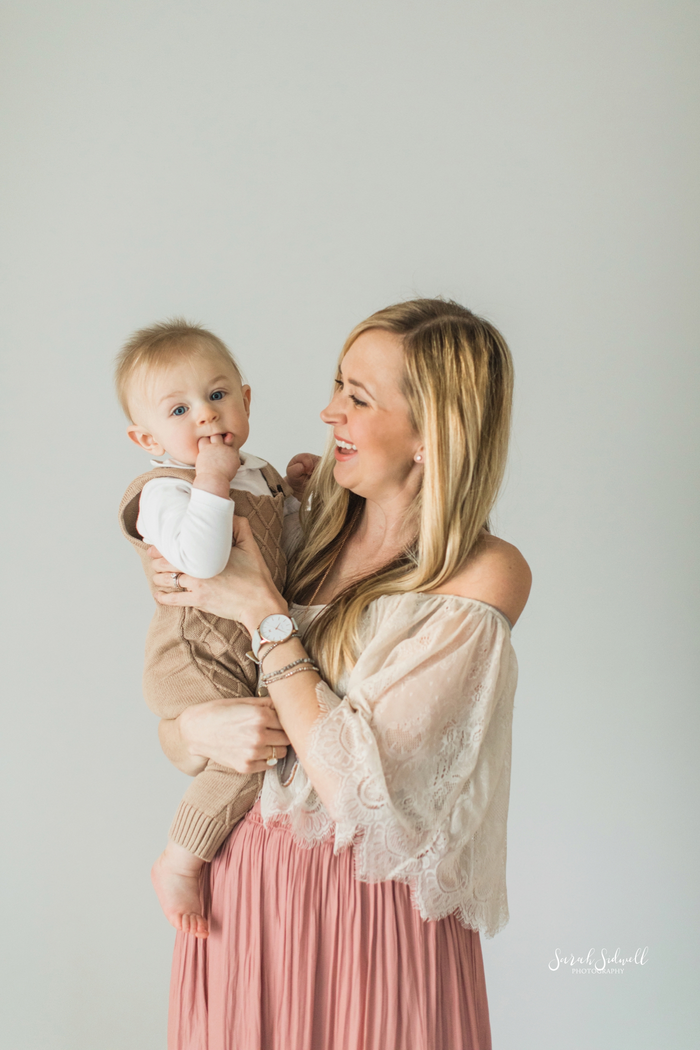 A mother holds her baby while celebrating his half birthday. | Sarah Sidwell Photography