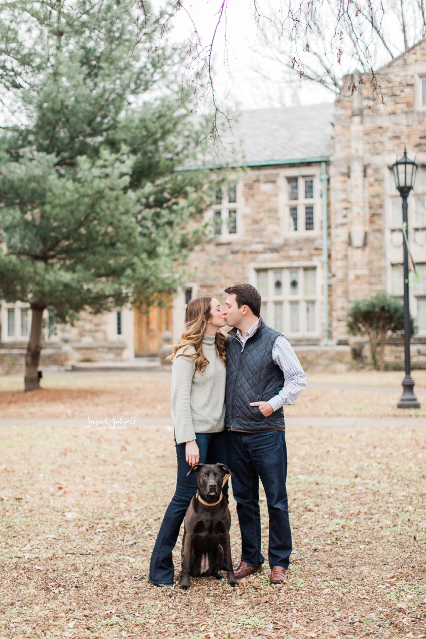A couple lean into each other while their Nashville engagement photographer captures the moment. 