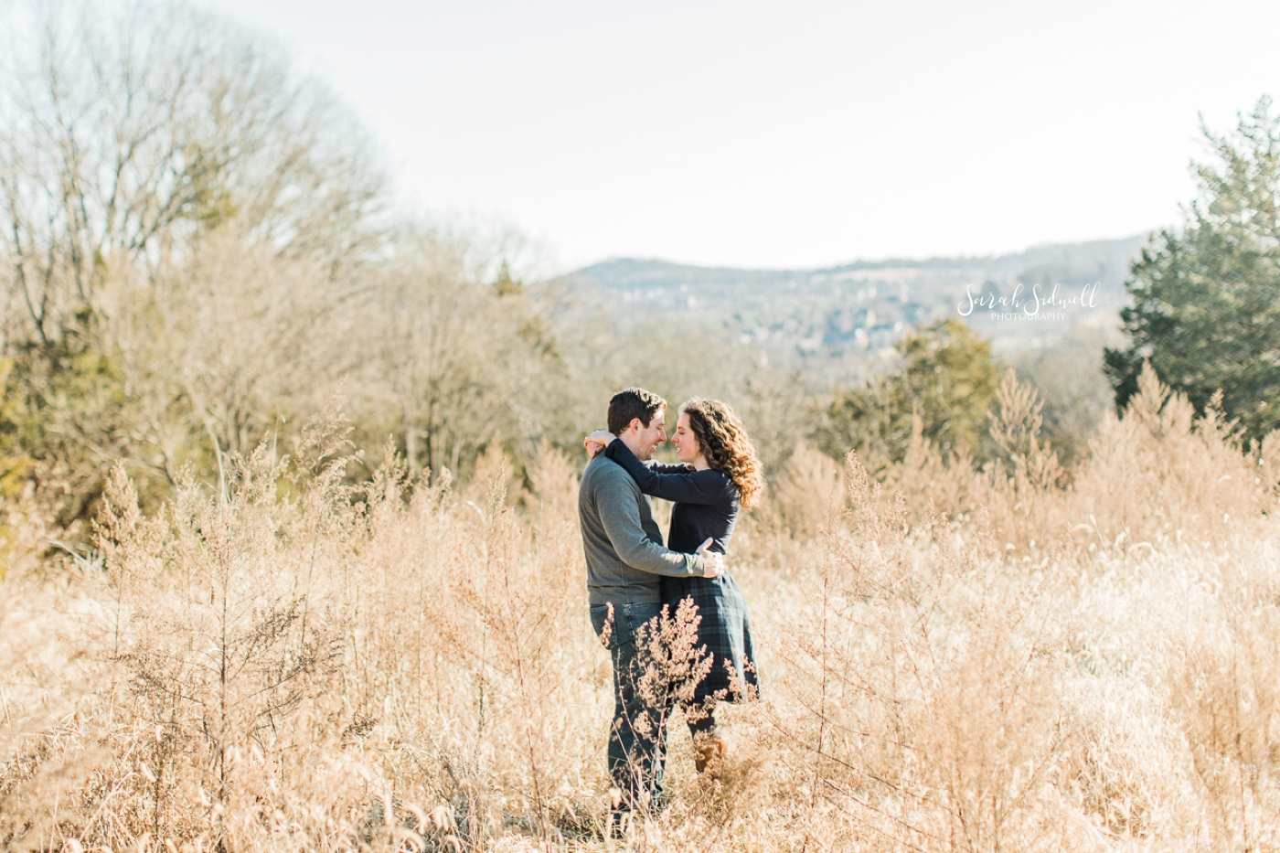 A couple dance in a field for their photo session by an Engagement Photographer in Nashville. 
