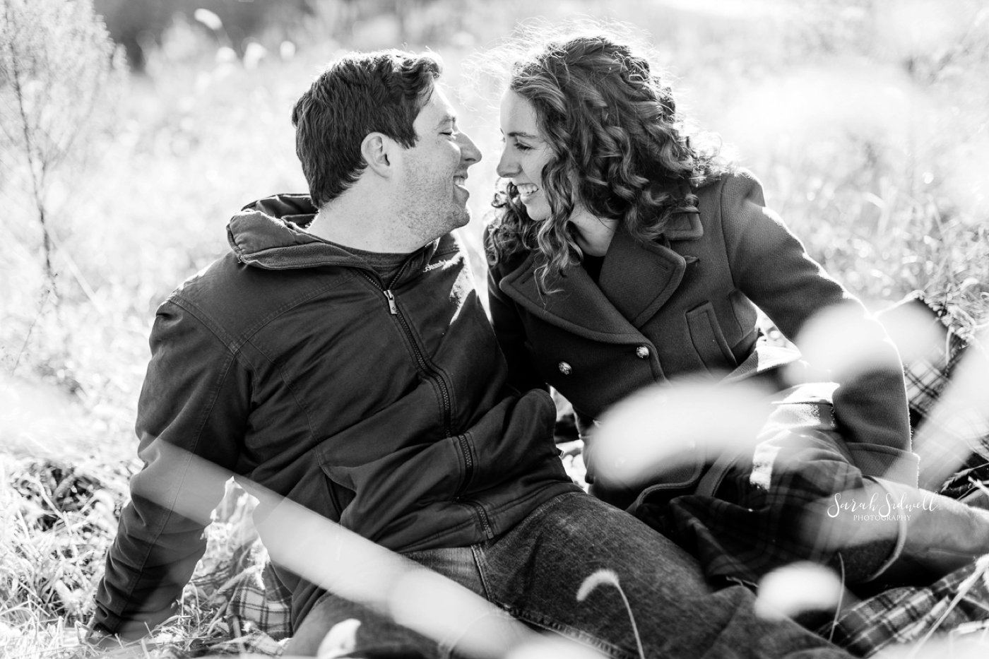 A couple laugh together during their photo shoot by an Engagement Photographer in Nashville. 