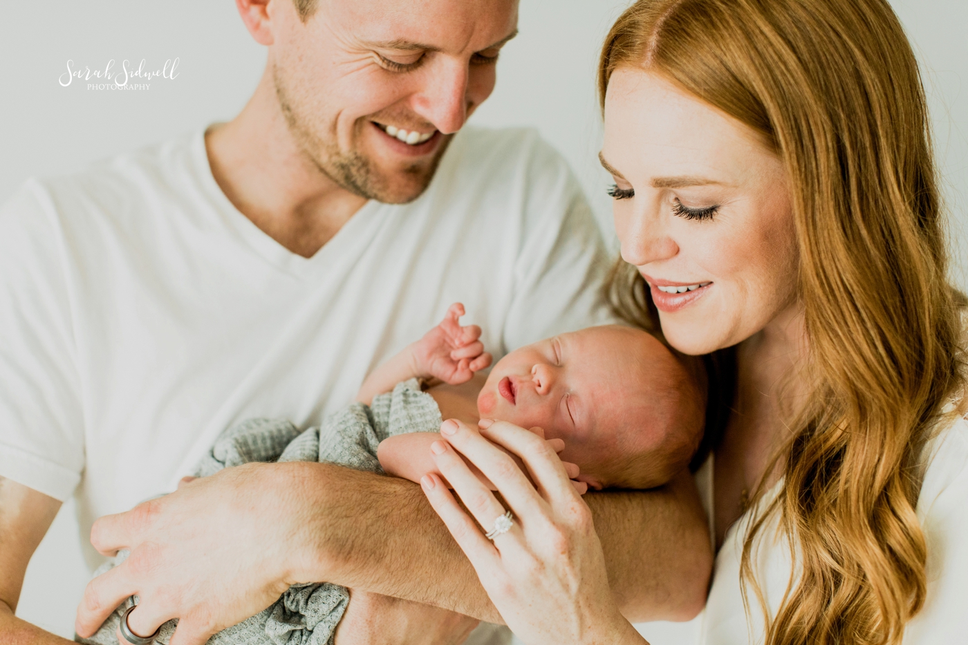 A couple smiles at their newborn | Newborn Photography Nashville