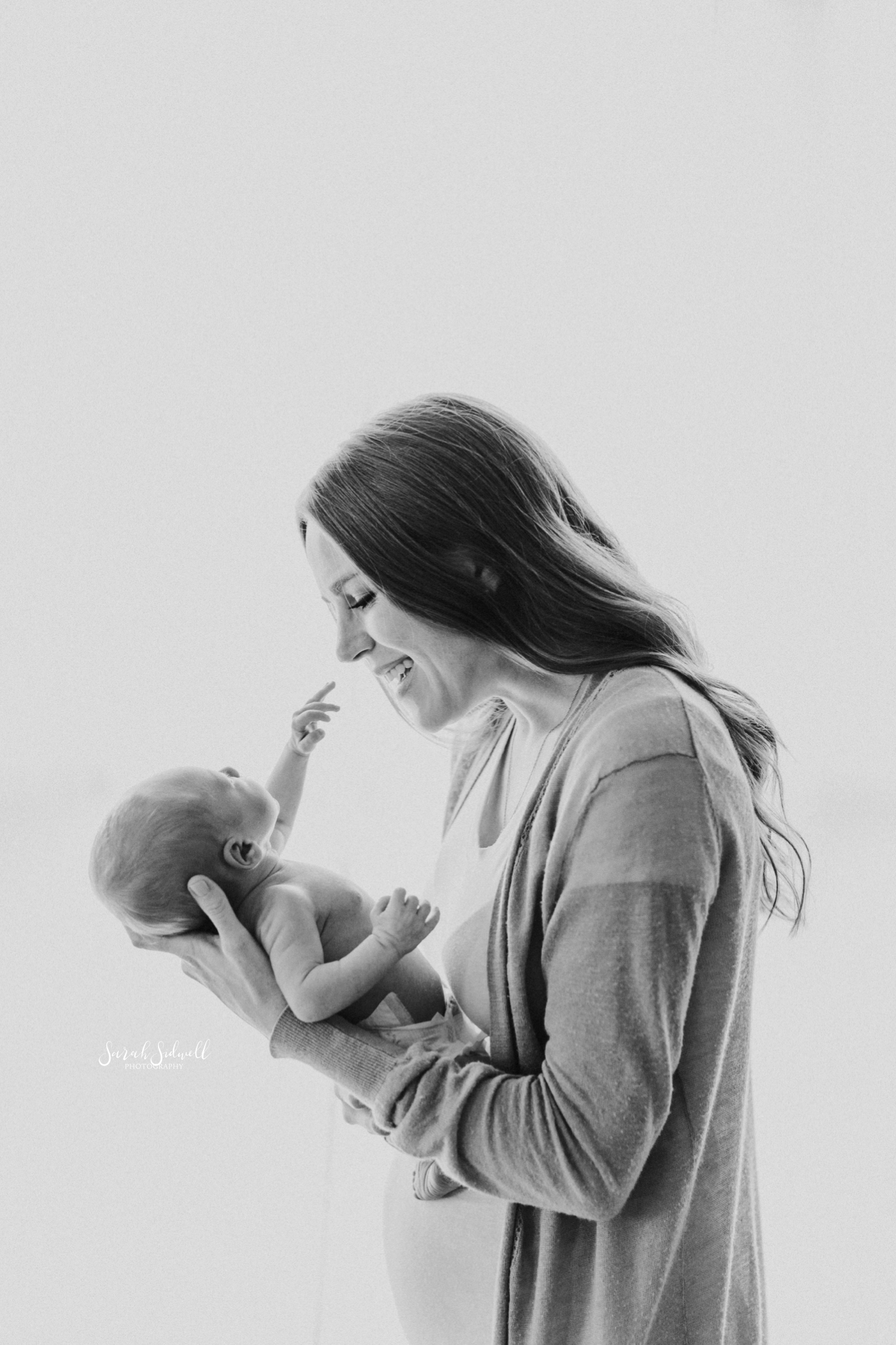 A mother talks to her newborn | Newborn Photography Nashville