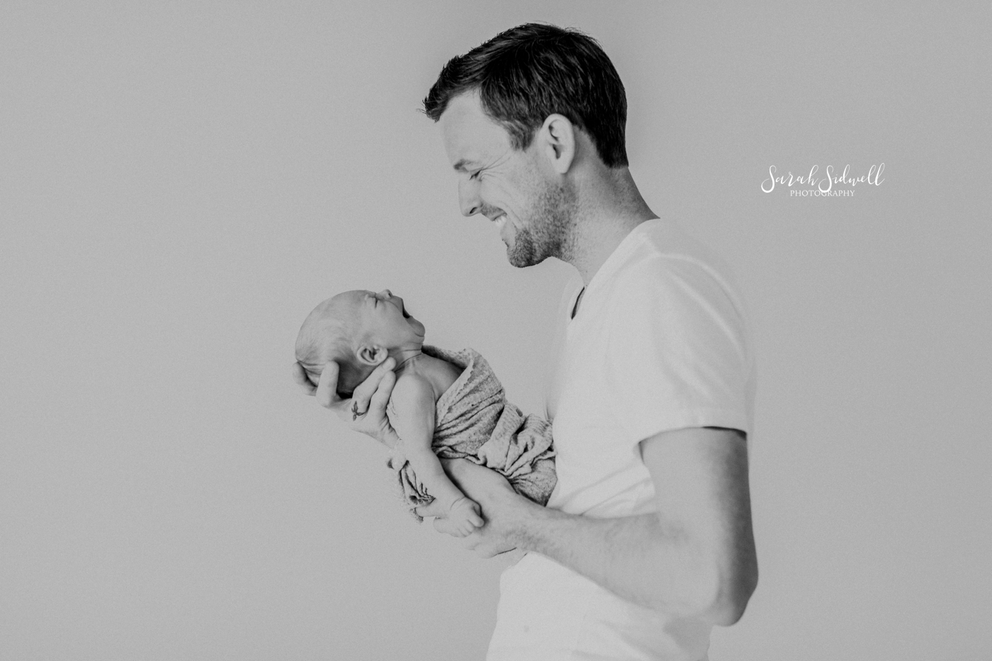 A father talks to his newborn | Newborn Photography Nashville