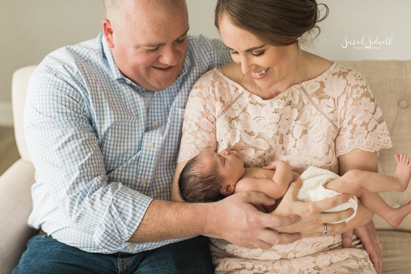 A couple admires their baby | Nashville Newborn Photographer
