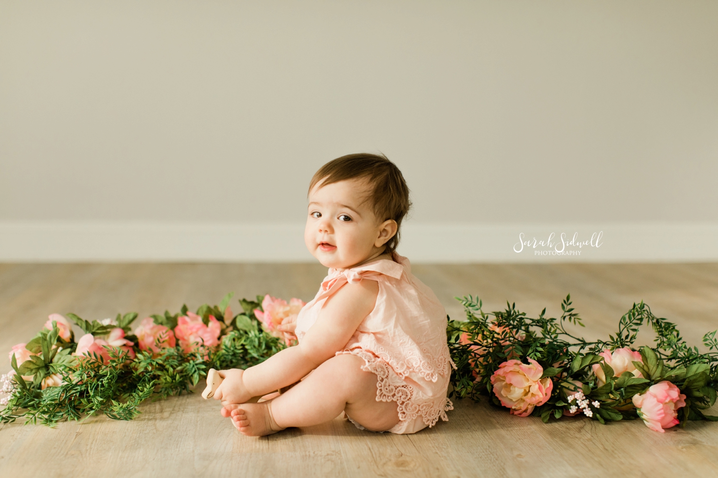 A baby sits in front of flowers | Nashville Baby Photographer 