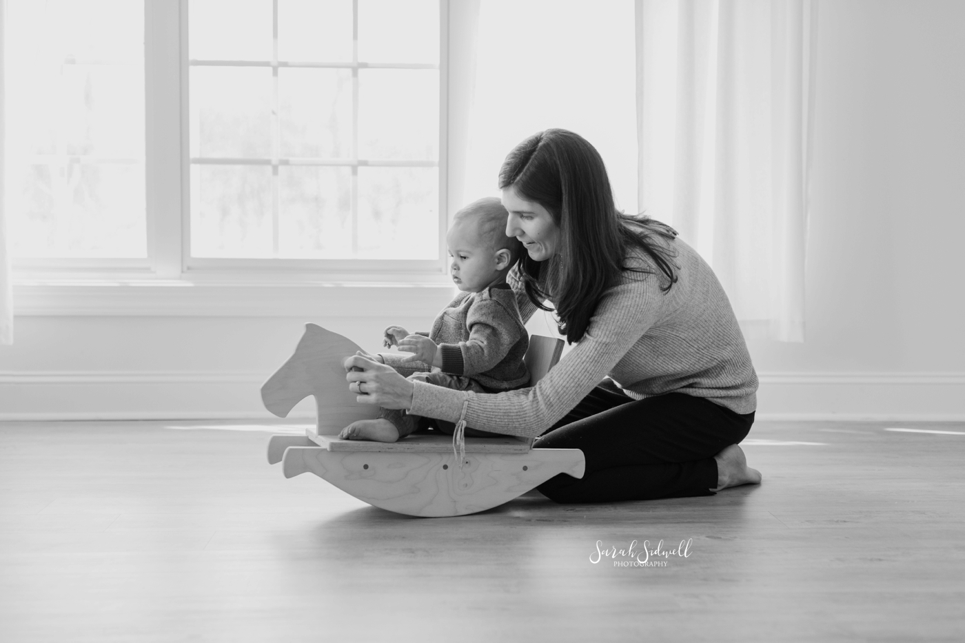 A baby rides a rocking horse | baby photography in Nashville. 