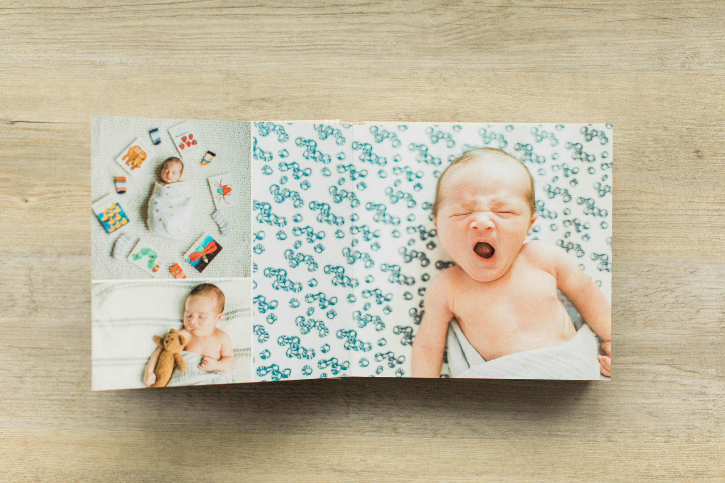 A photo of a baby yawning is inside of a baby photo album. 
