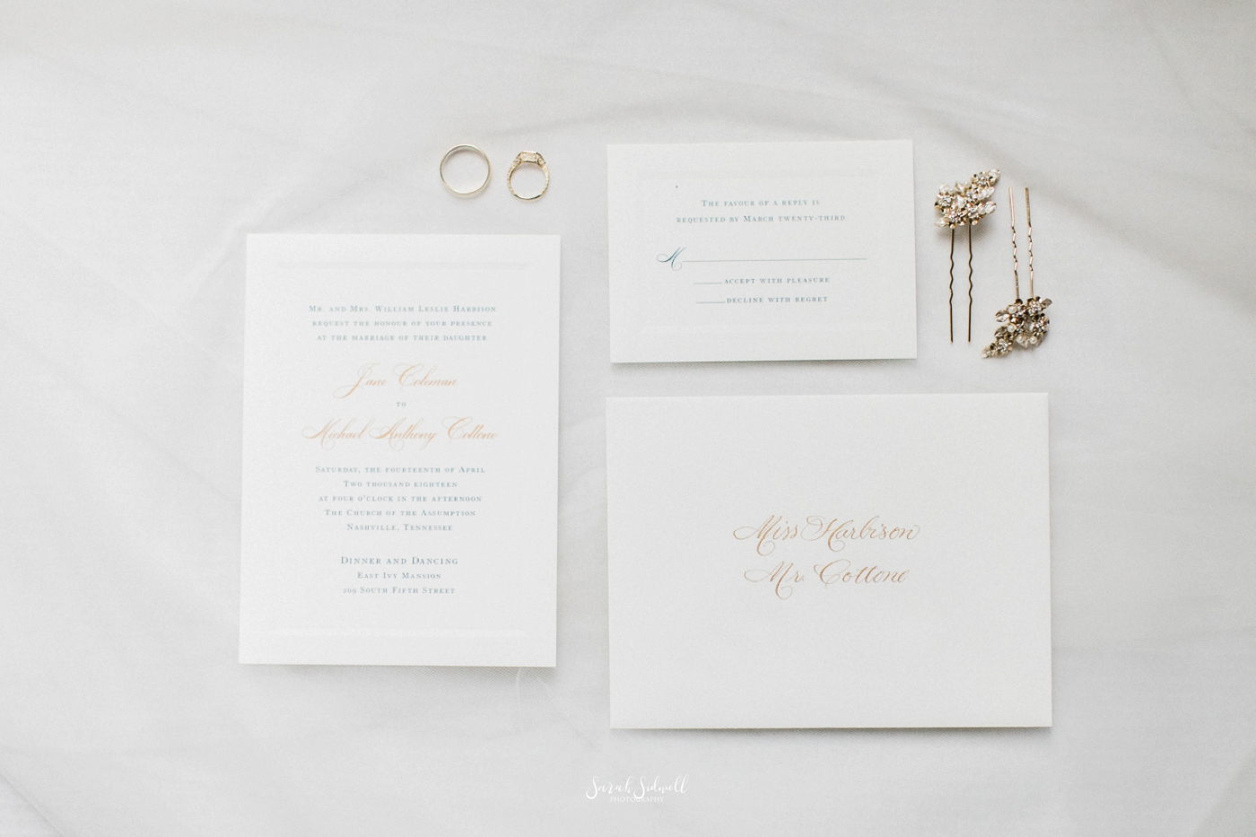 Wedding invitations are displayed on a white table. 