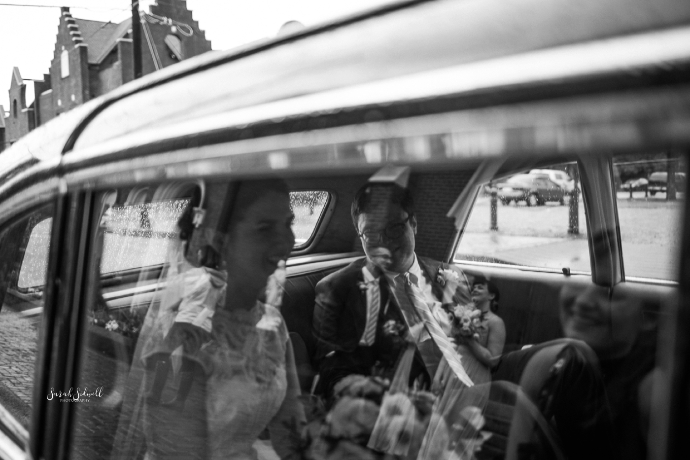 A bride and groom get into their ride after their ceremony. 