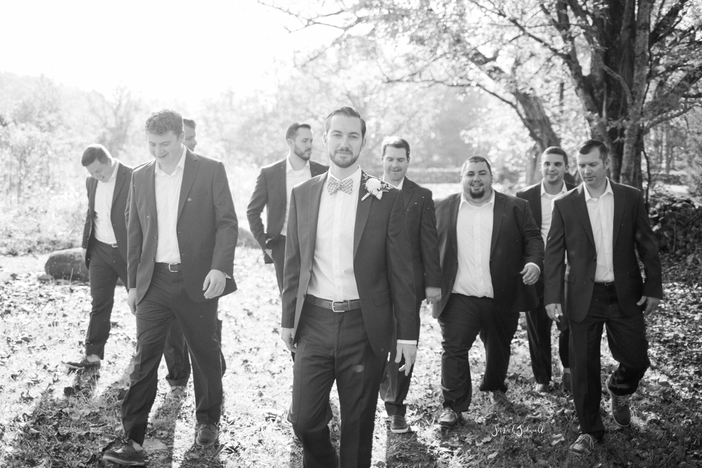A groom stands with his groomsmen before the ceremony. 