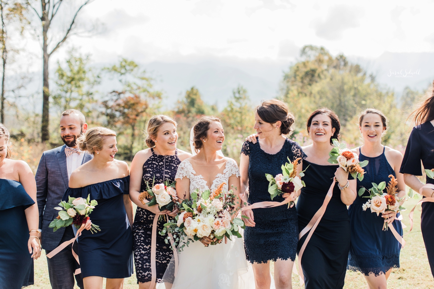 A bride is surrounded by her bridal party. 