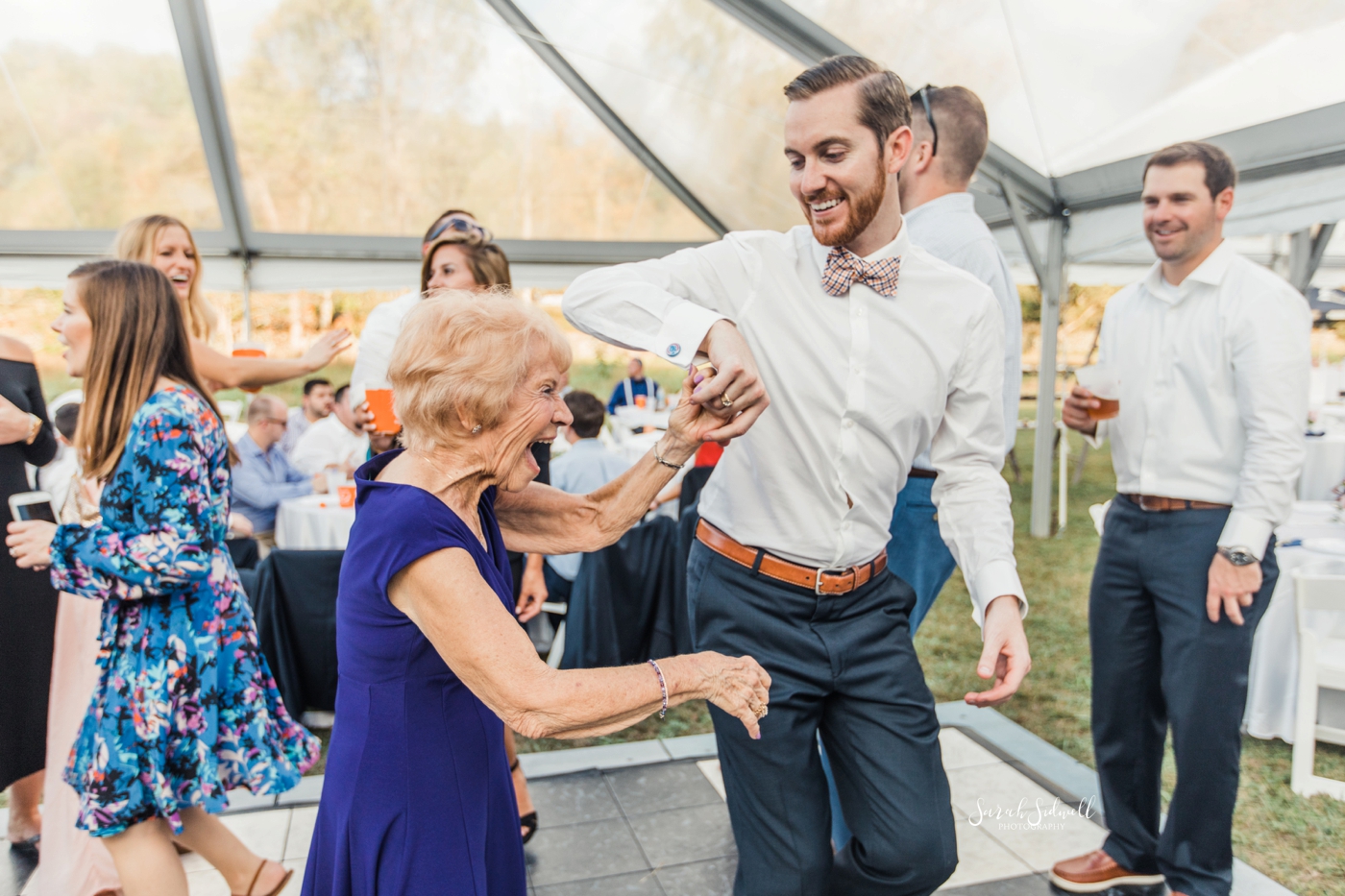 A groom dances with his mom at his wedding. 