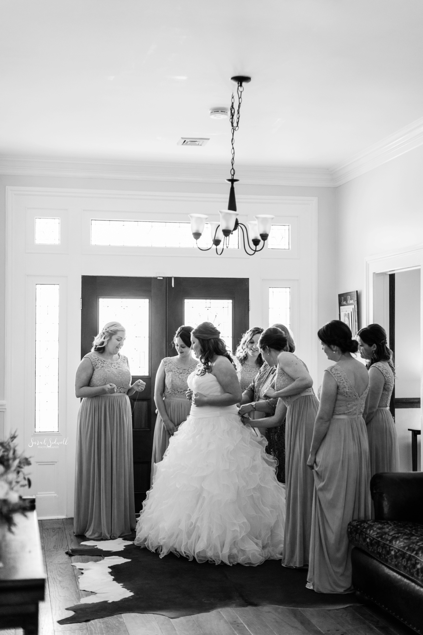 A bride gets ready for her wedding with her friends. 