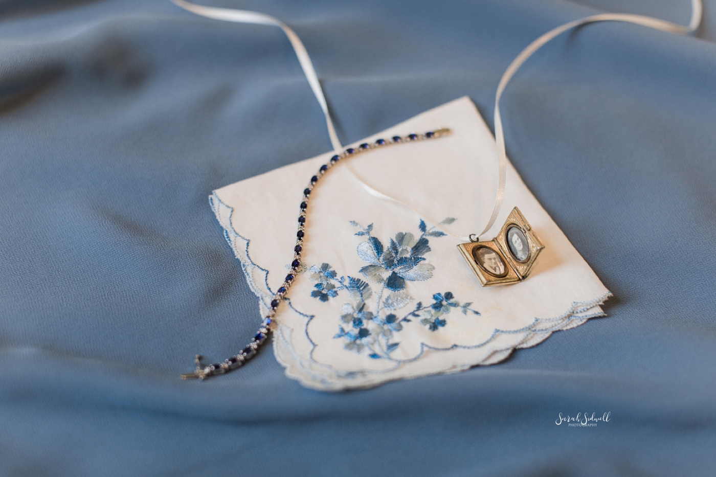 A cloth is embroidered with blue flowers for a bride's wedding day. 