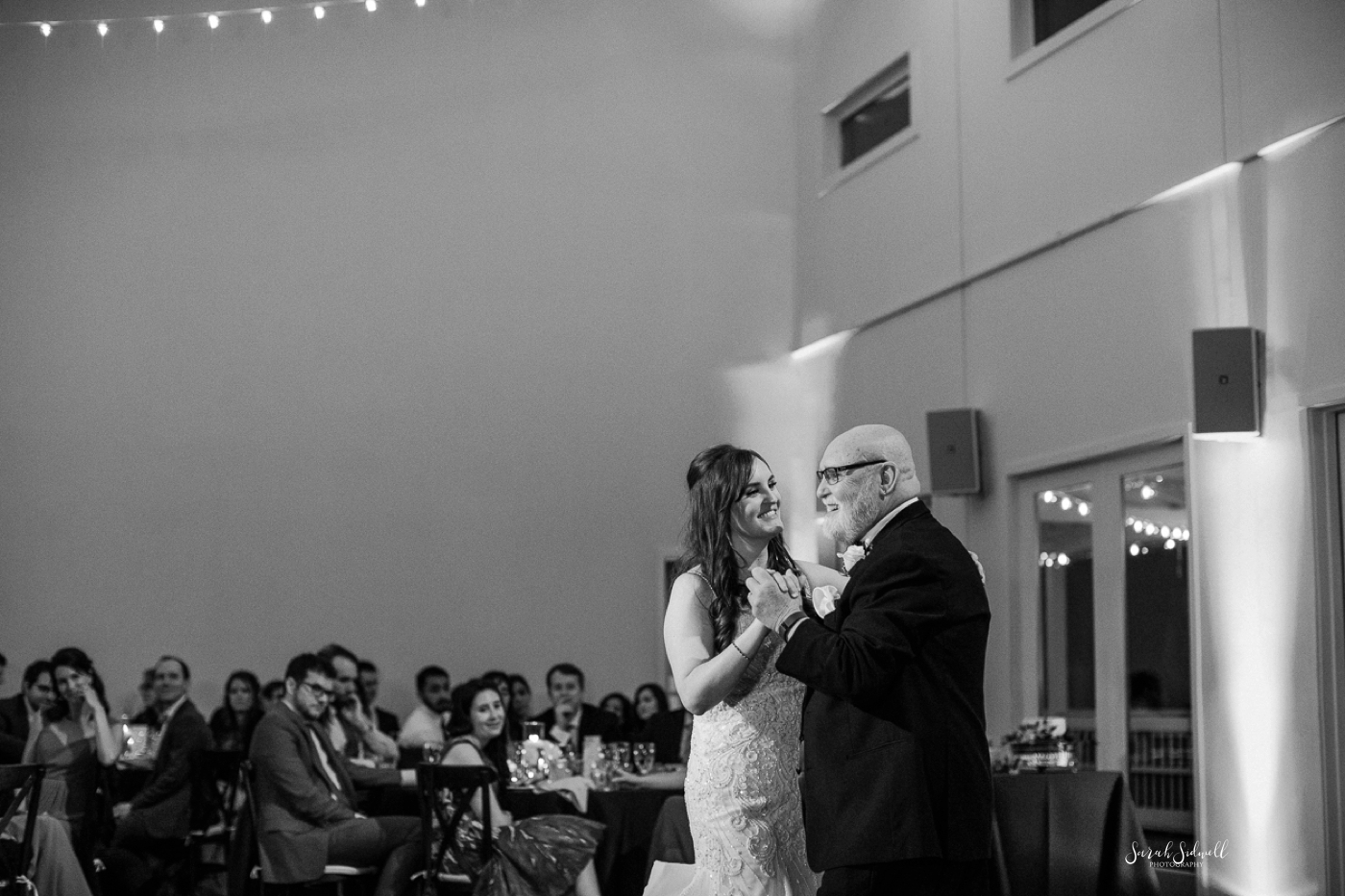 A woman dances with her father at her wedding. 