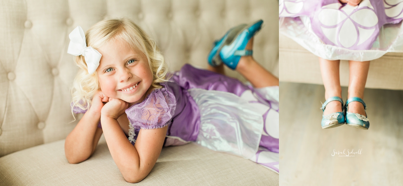 A girl lays on a couch during some family photography sessions. 