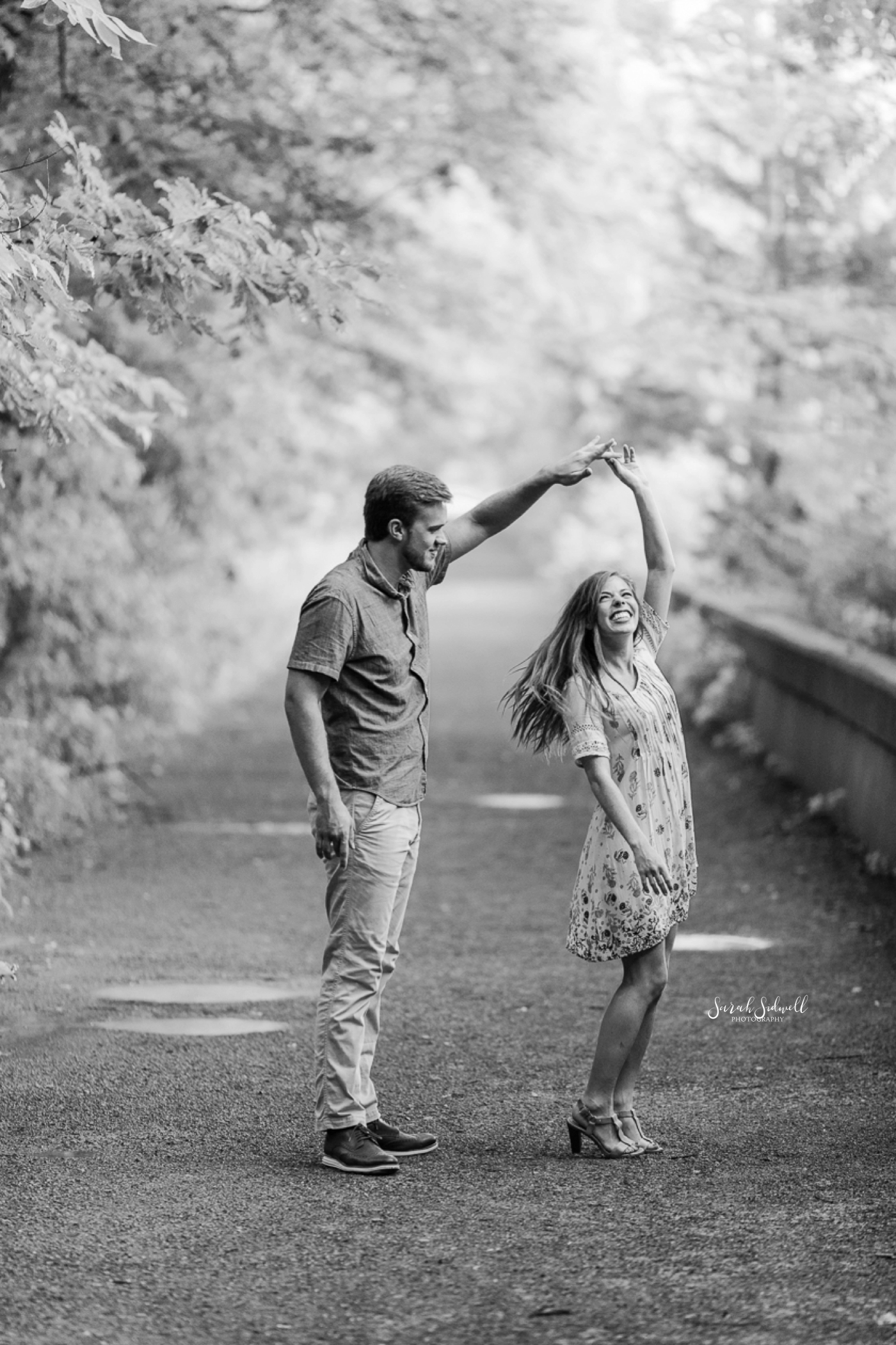 A couple dance on a dirt path at Radnor Lake. 