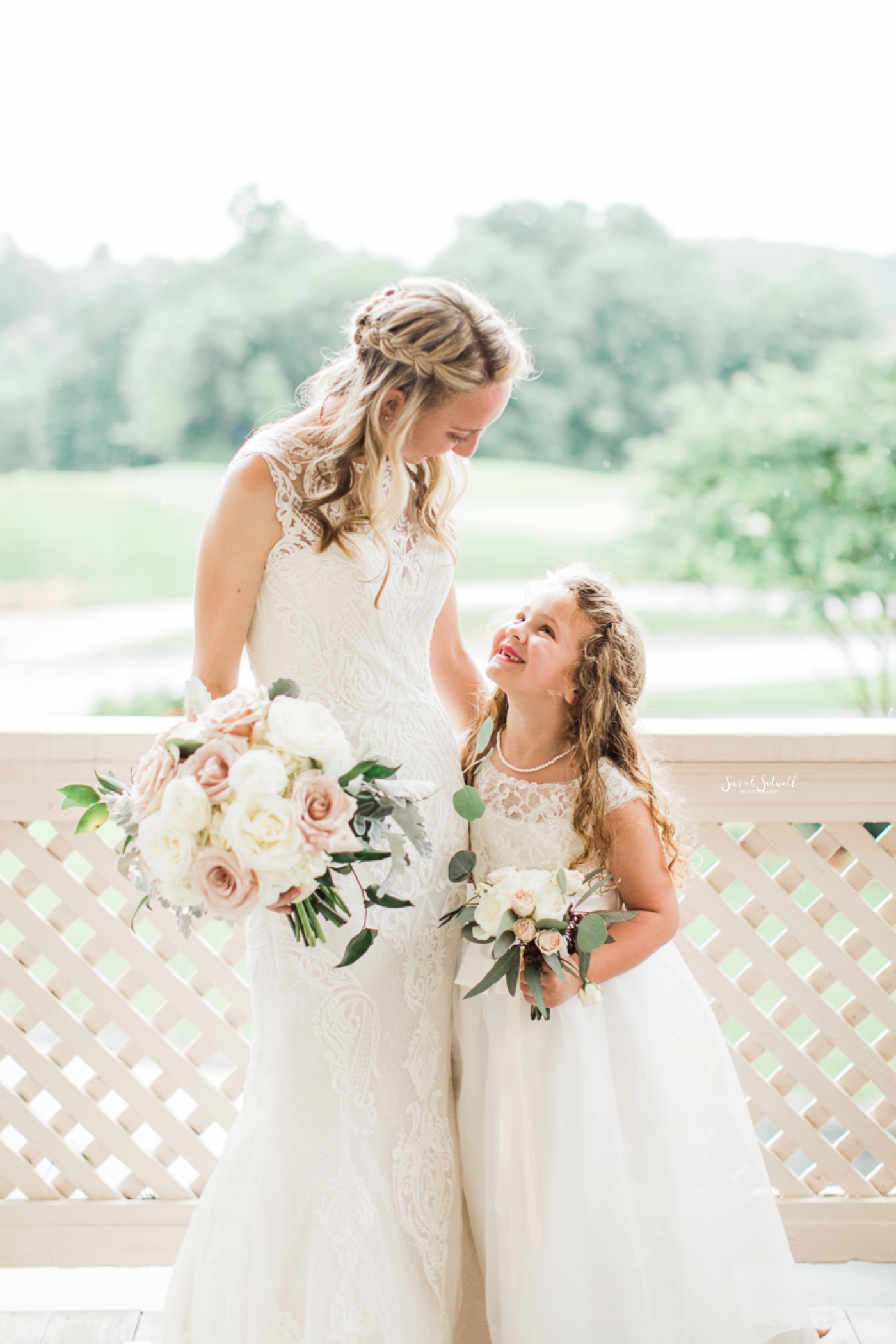 A bride hugs her flower girl after the ceremony. 