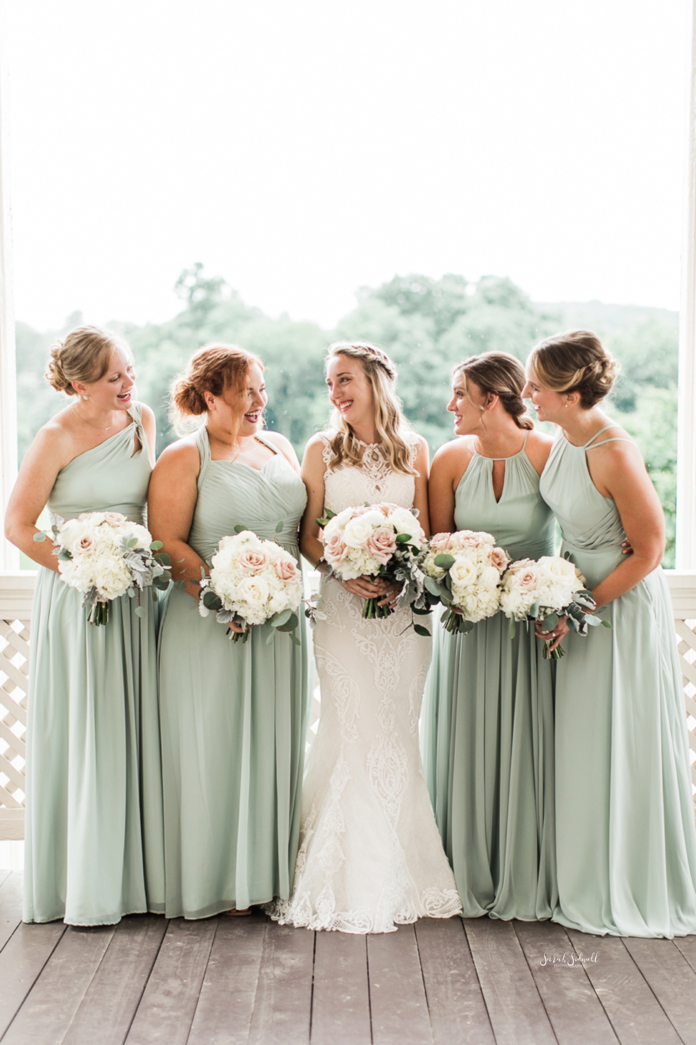A bridal party surrounds the bride after the wedding. 