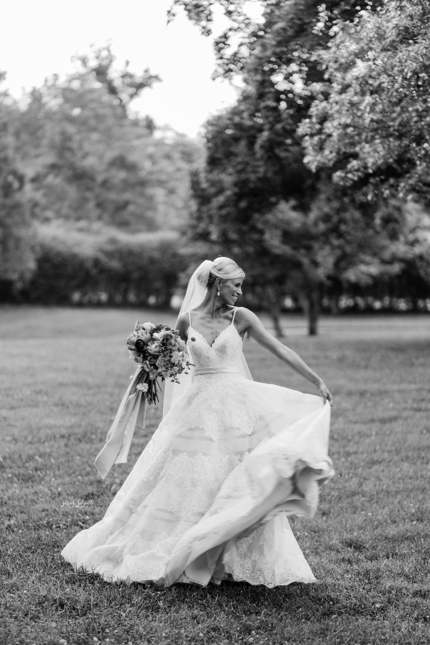 A bride twirls in her wedding dress. 