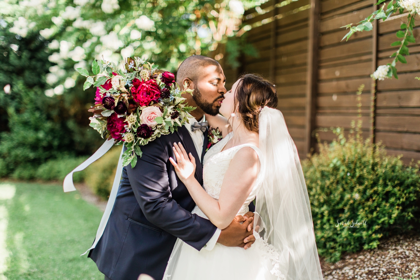 A groom kisses his bride before their Cordelle wedding. 