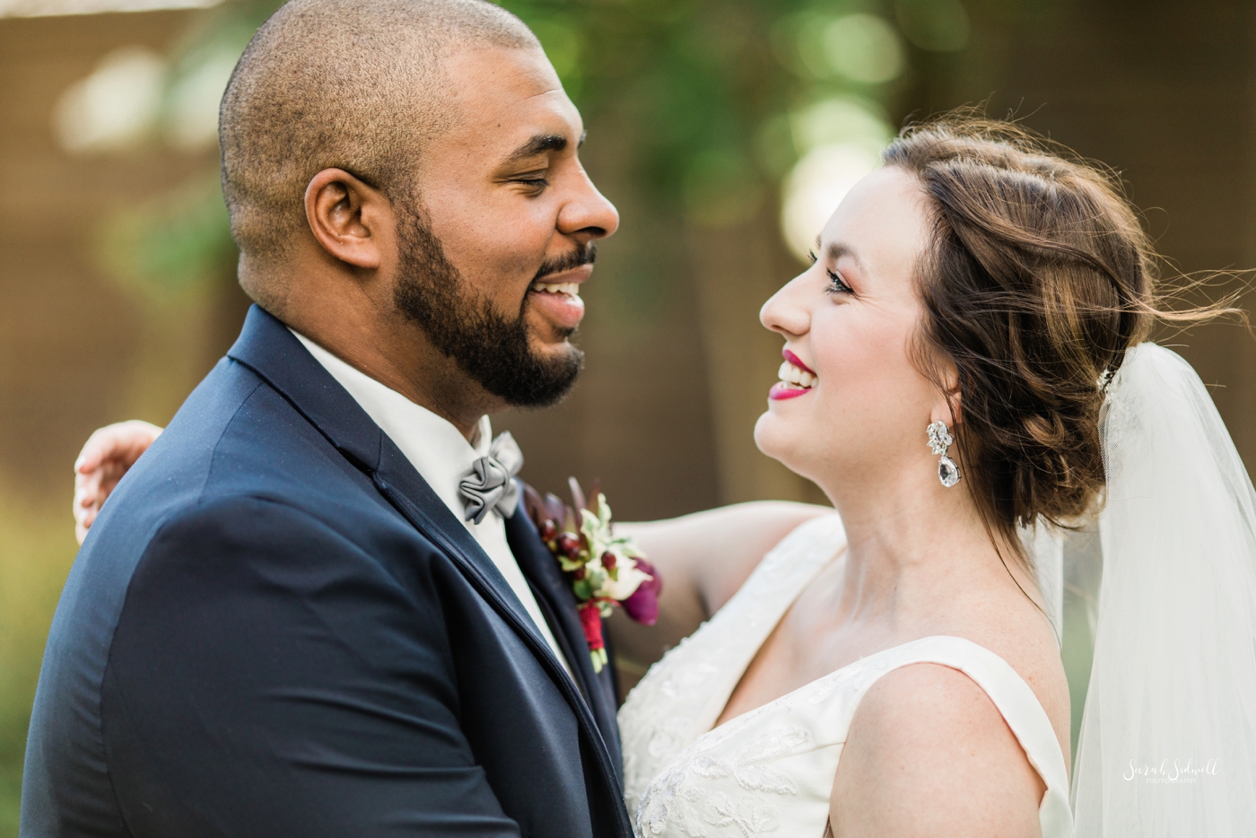 A bride and groom share a laugh before their Cordelle wedding. 