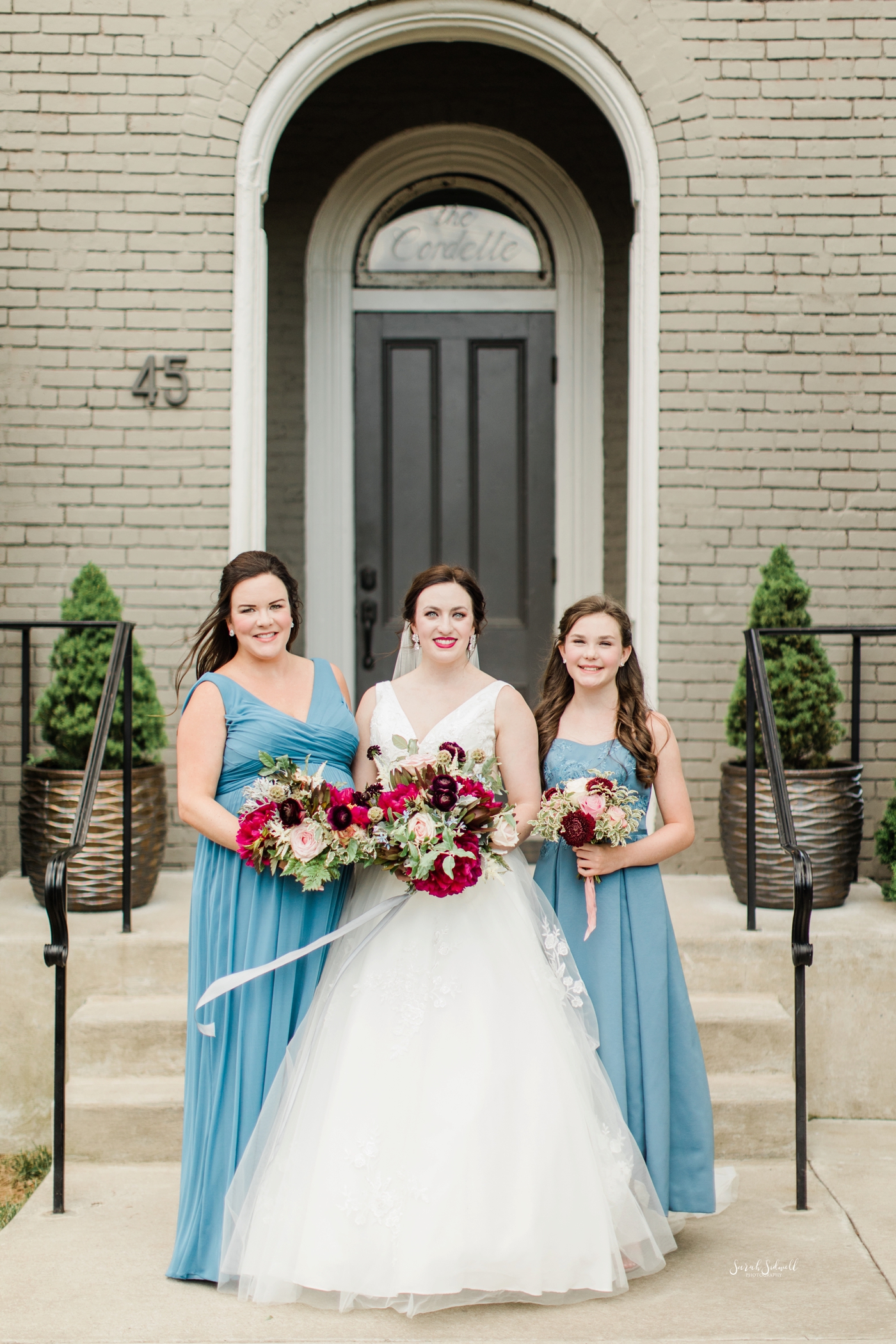 A bride stands with her bridesmaids. 