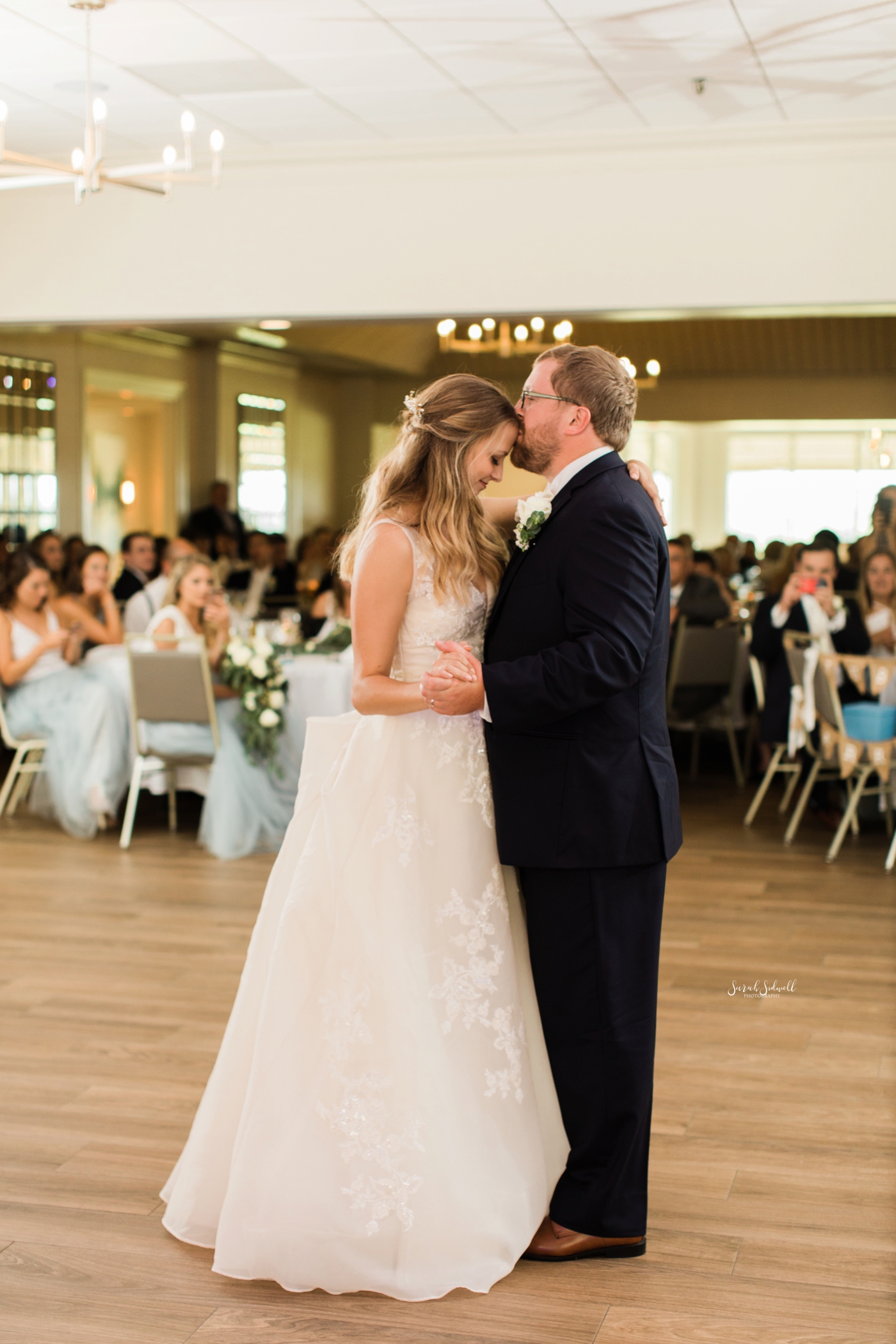A bride shares a first dance with her groom. 