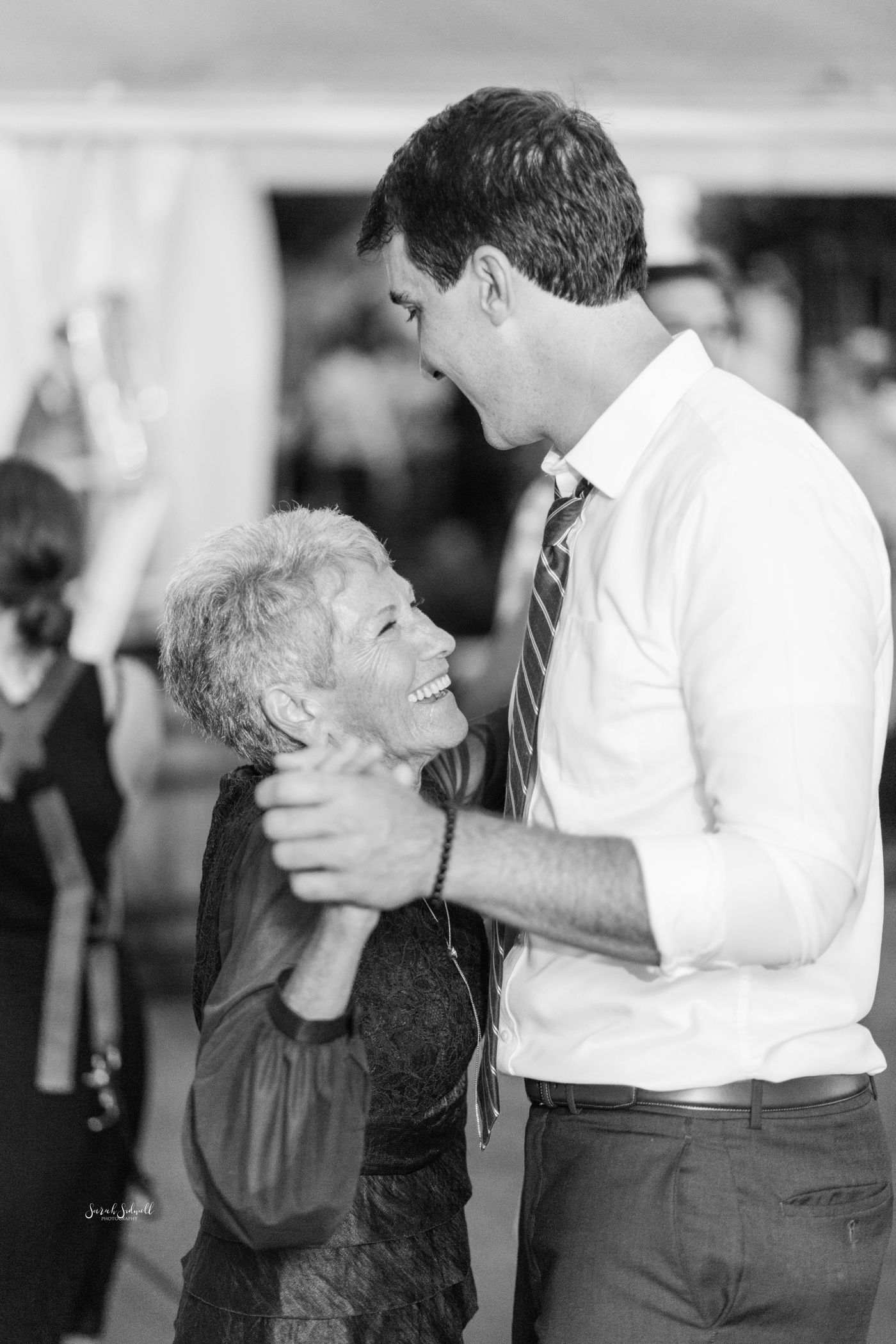 A groom dances with his mother at his wedding. 
