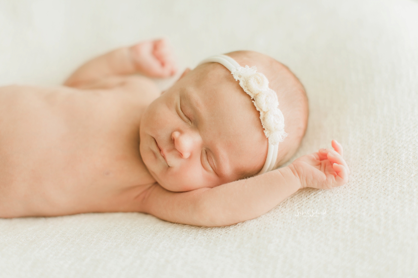 A newborn baby naps peacefully. 