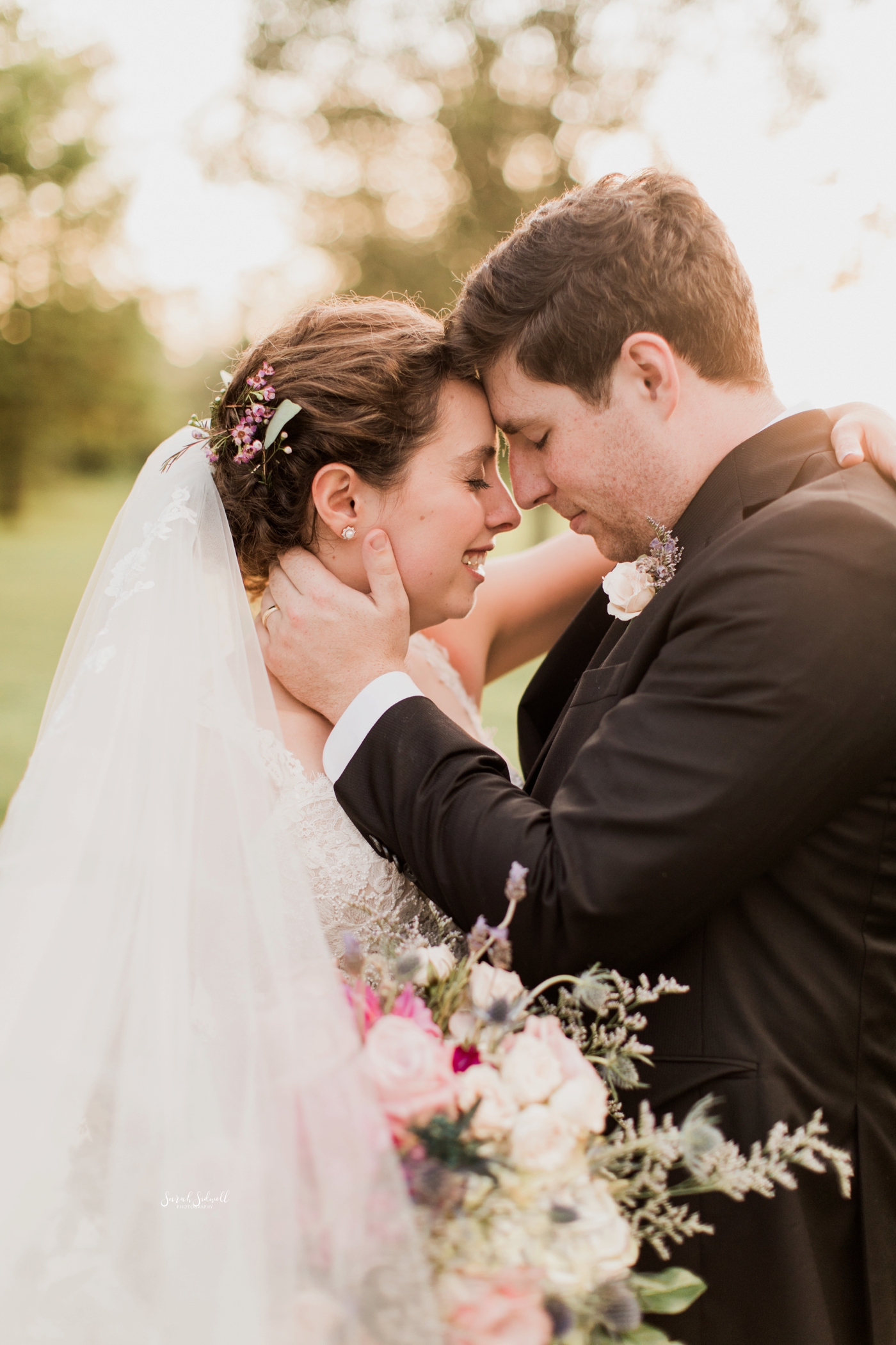 A man kisses his bride at their wedding. 