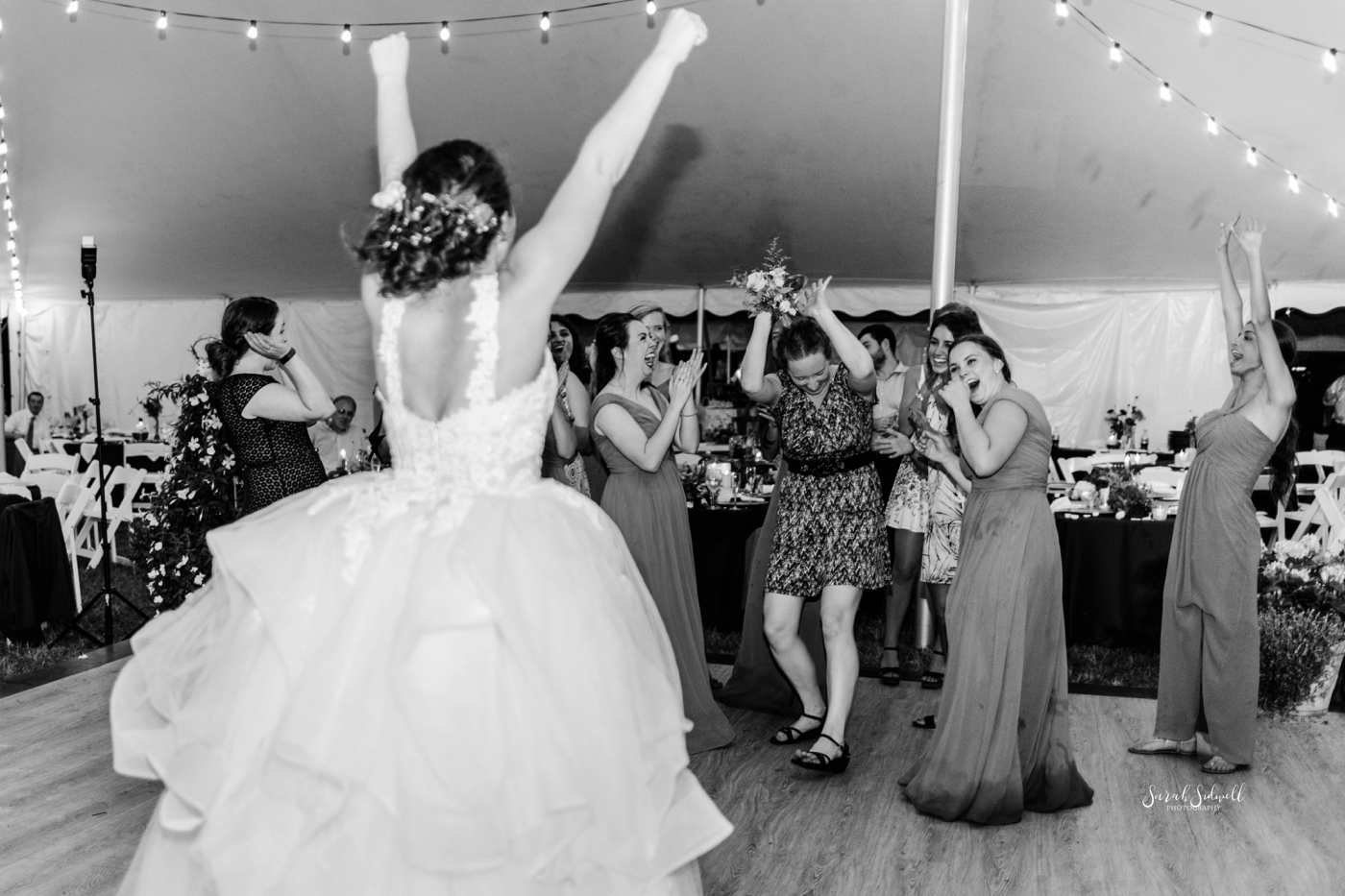 A bride dances at her wedding. 