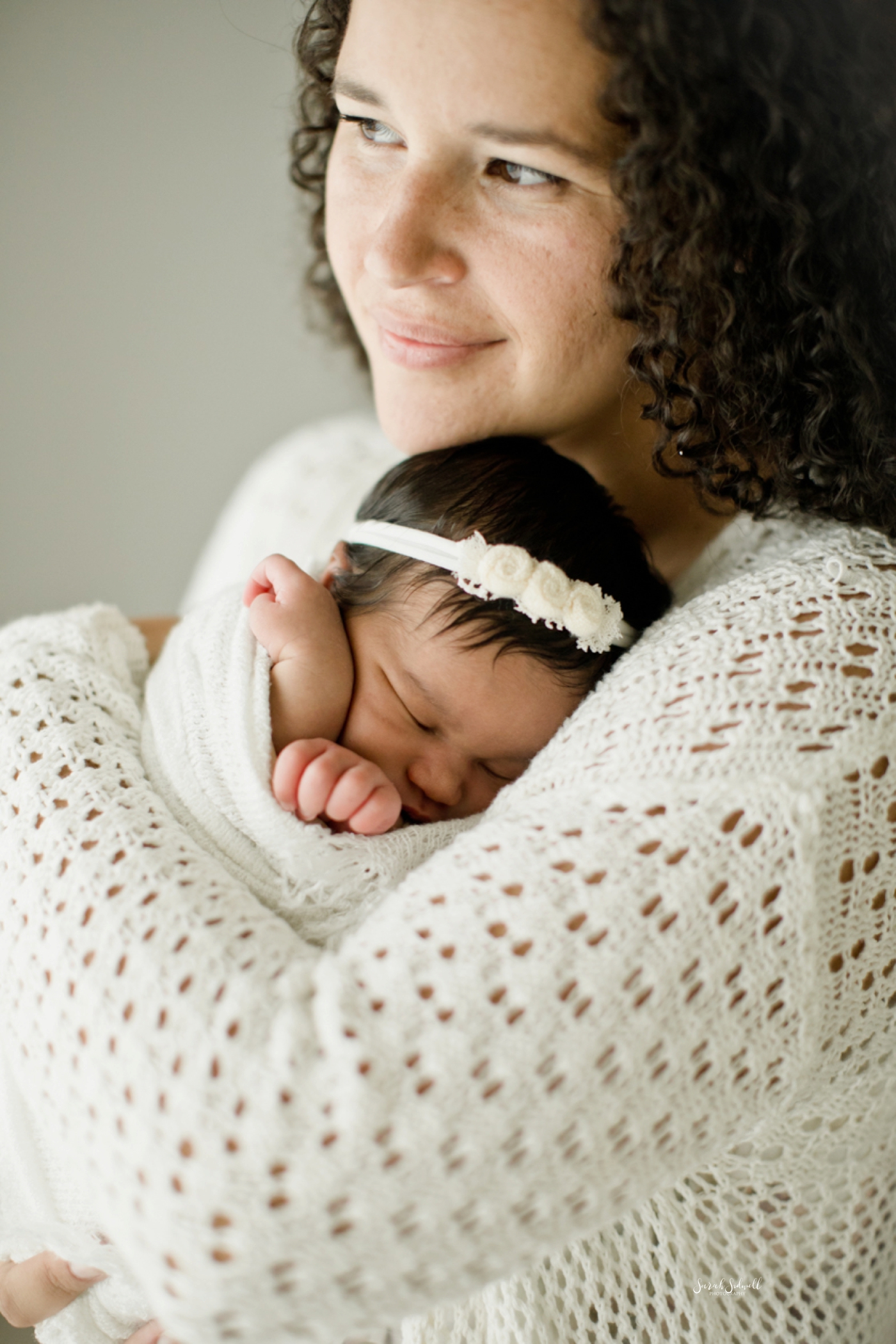 A baby sleeps on her mom during their Nashville newborn pictures. 