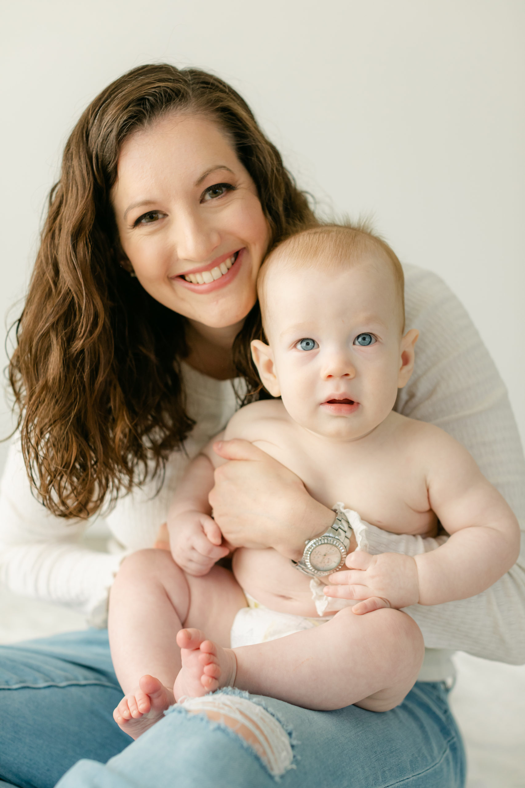 Mom with baby boy. Baby boy with big blue eyes. In studio photography in Nashville TN.