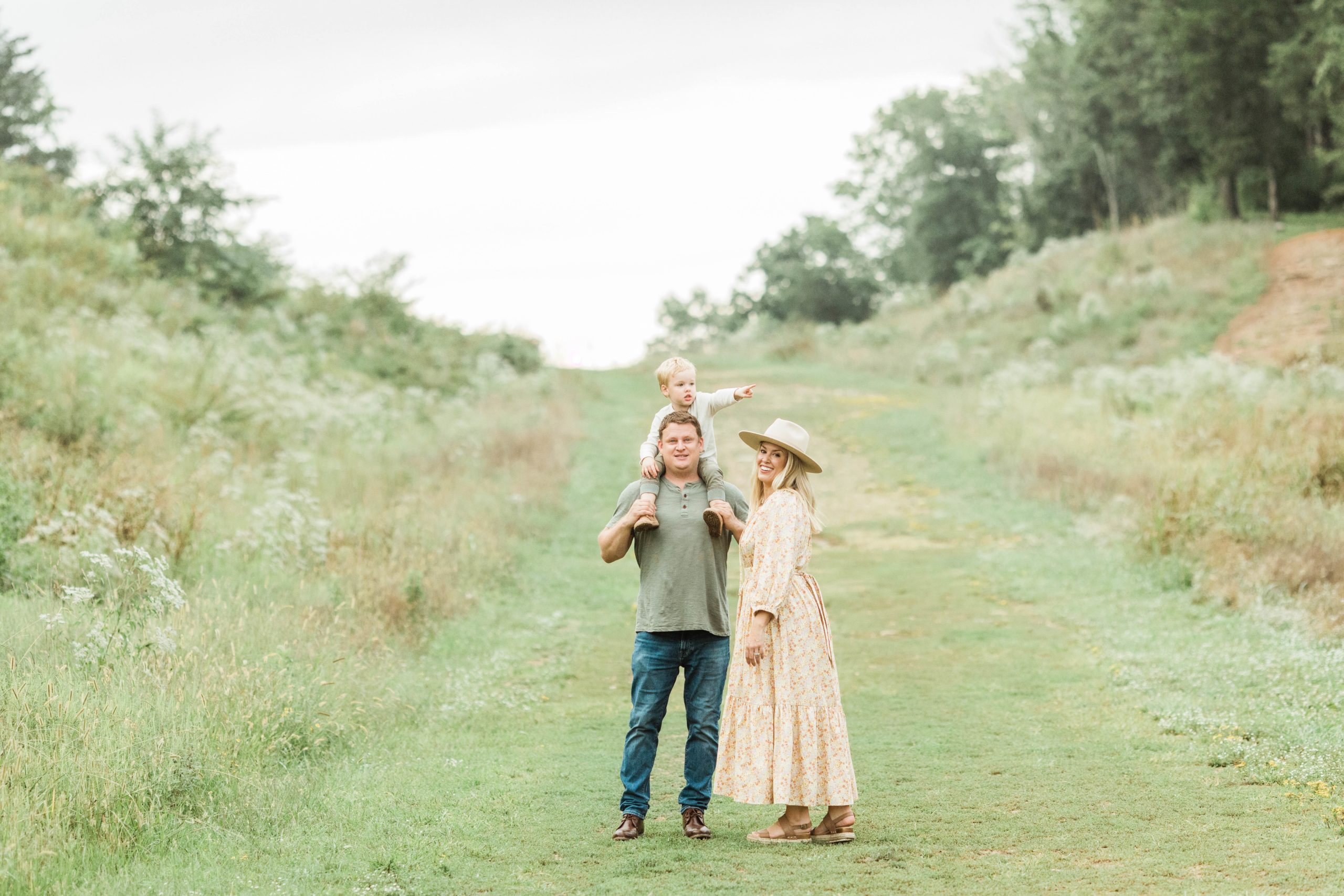 outdoor fall family photos. mom in long sleeve maxi dress. dad in jeans and green short sleeve. 