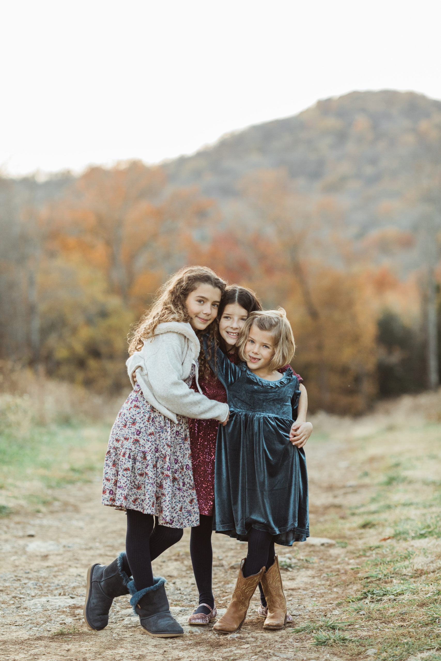 Fall family photos. Three sisters hugging.