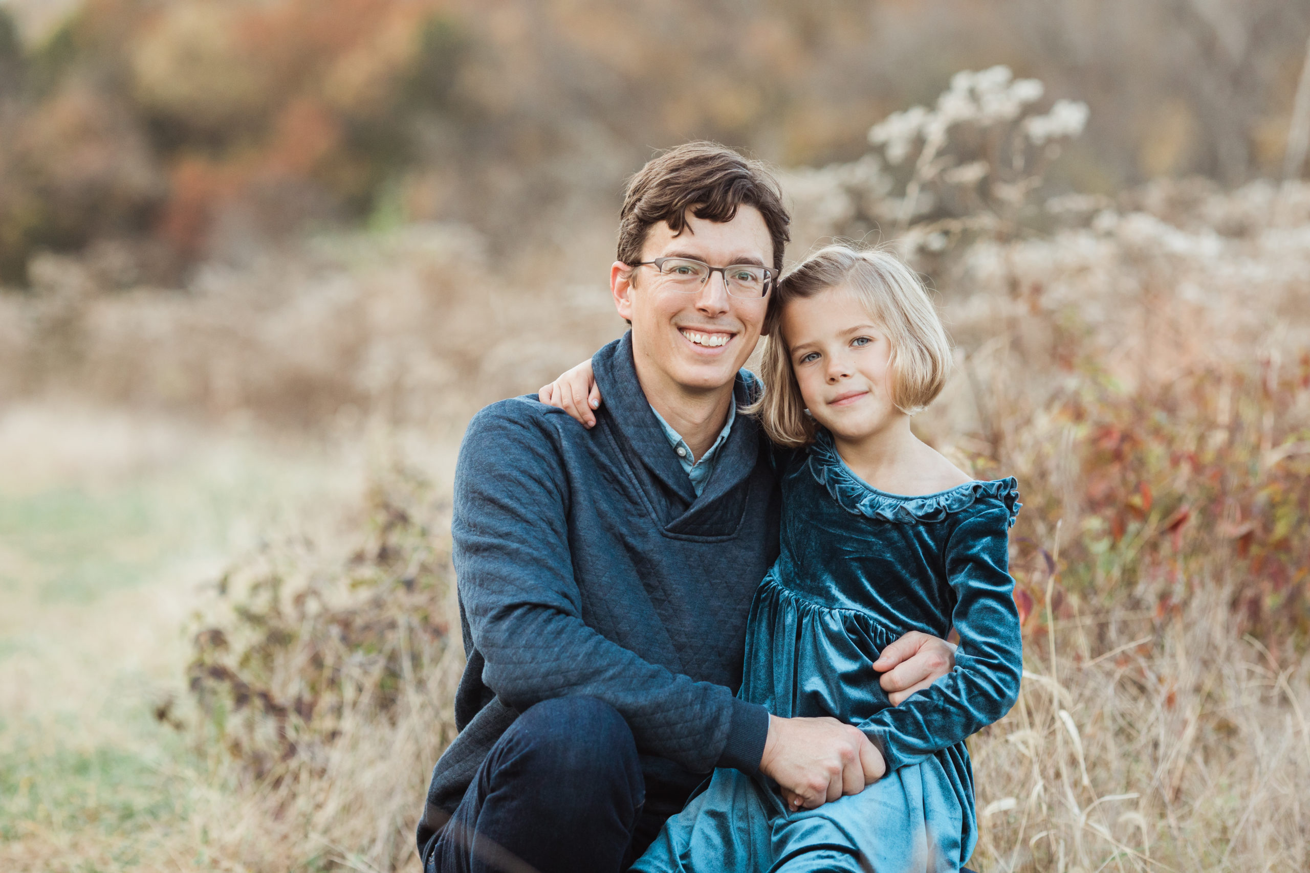 Dad with youngest daughter. Fall portraits.