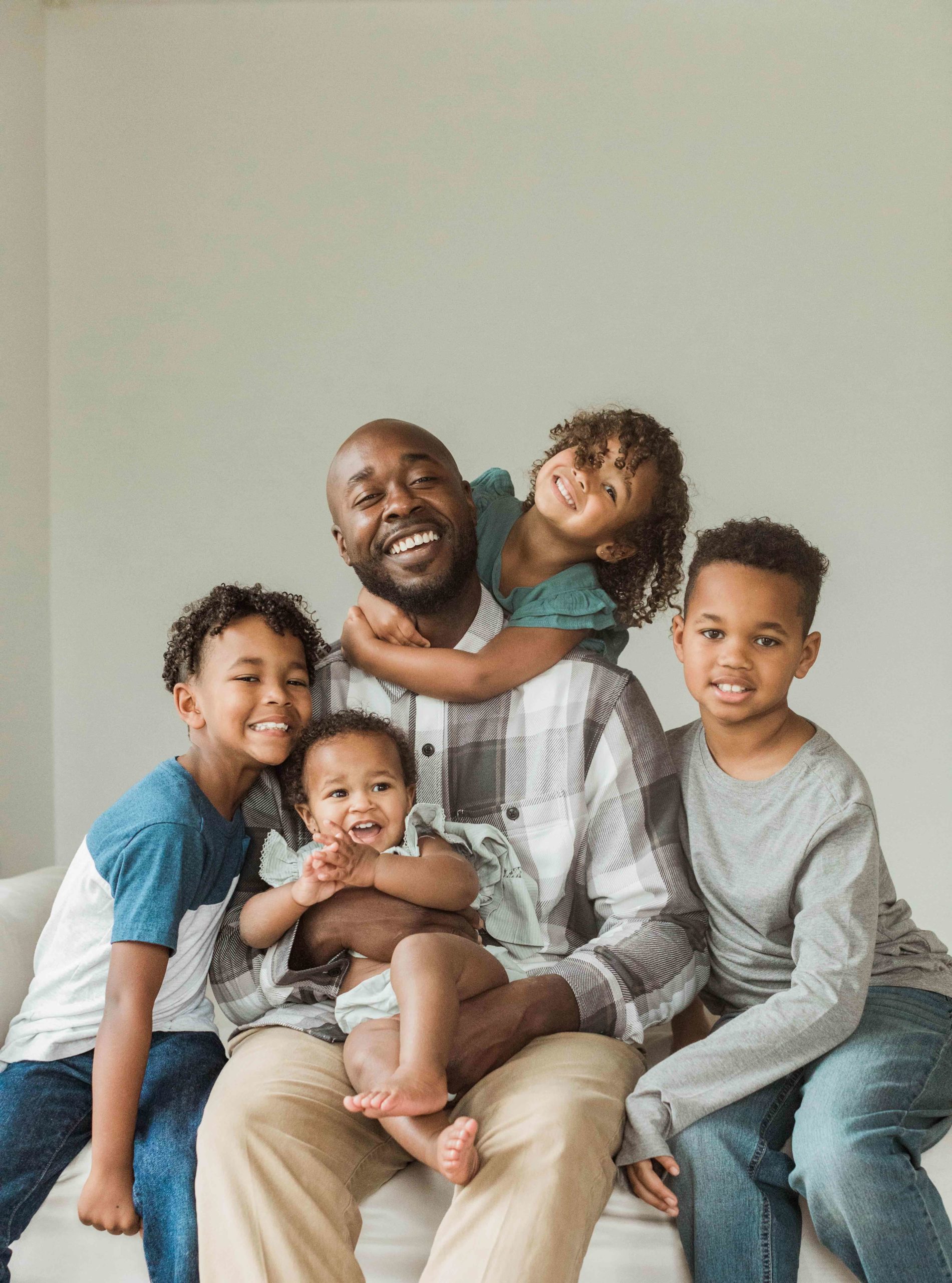 photo of dad with his four smiling kids. Nashville family photographer.