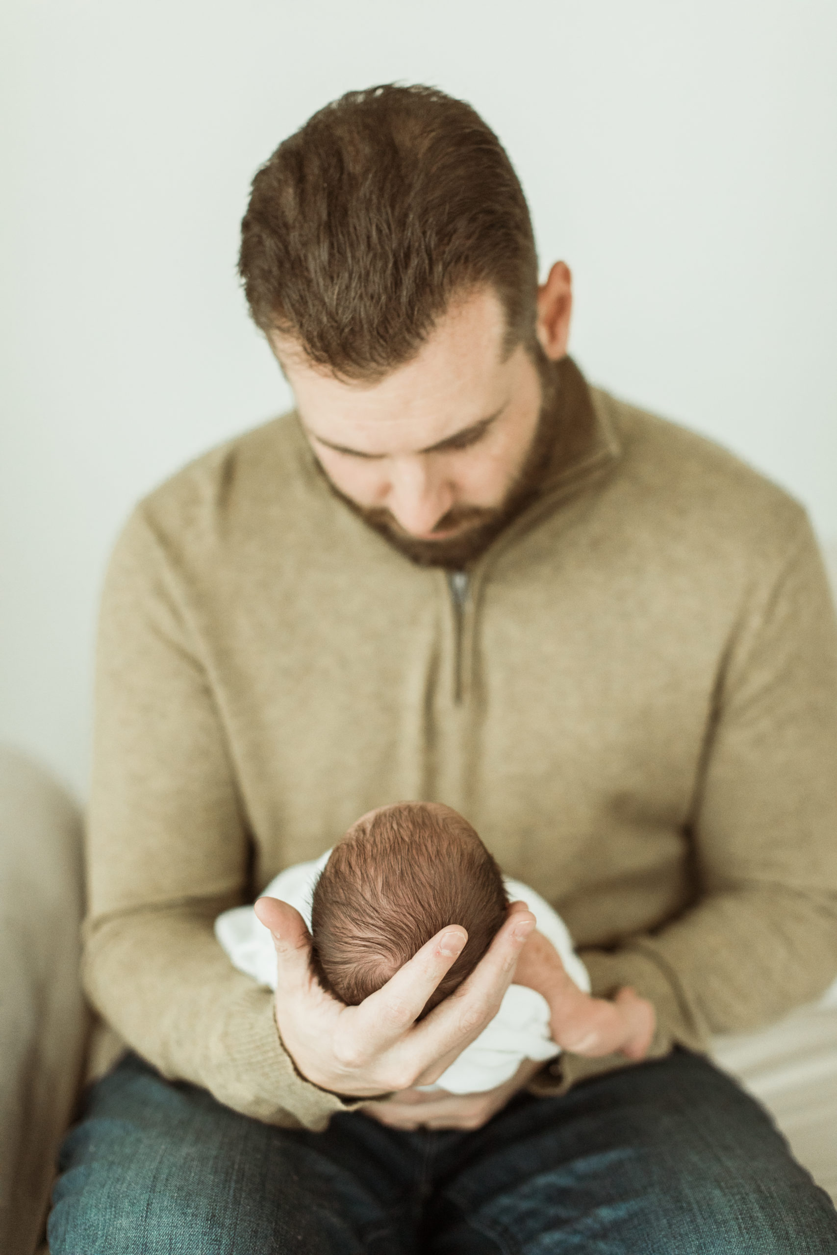 photo of dad holding his newborn son