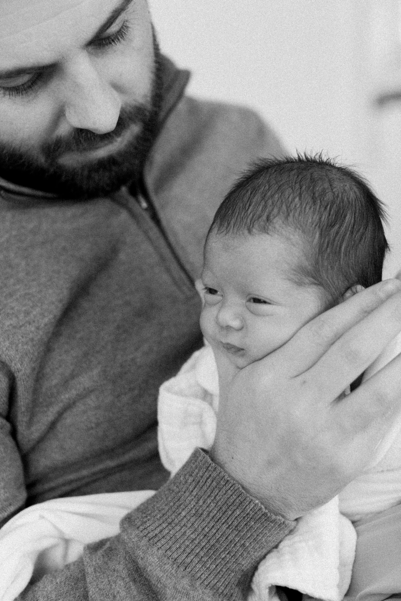 black and white photo of dad with newborn son