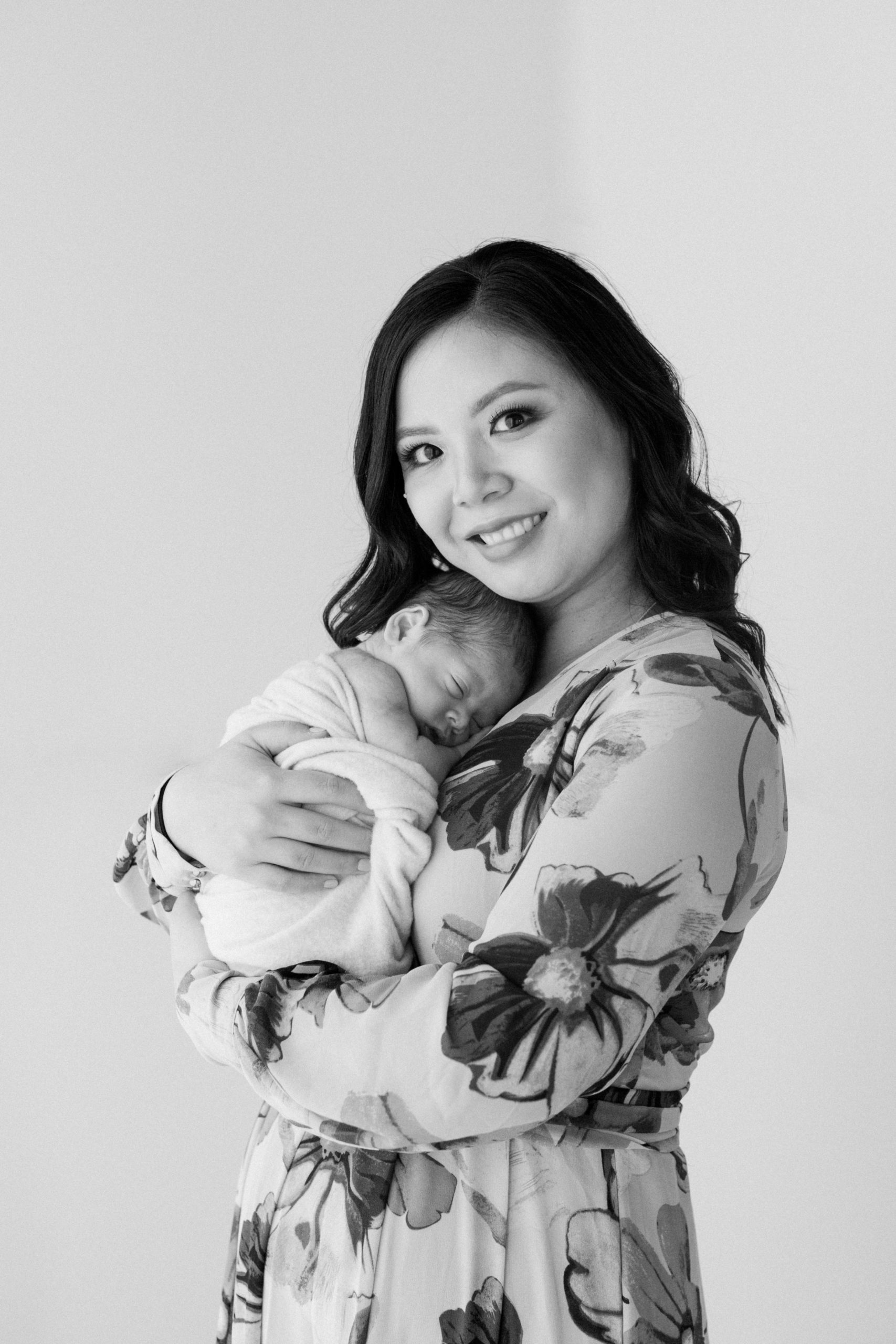 black and white photo of first time mama with newborn baby boy.