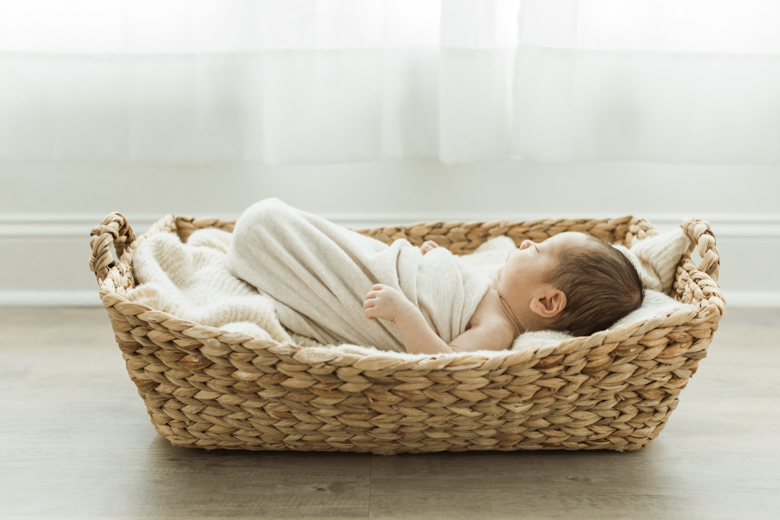 newborn baby boy sleeping in basket. newborn photography