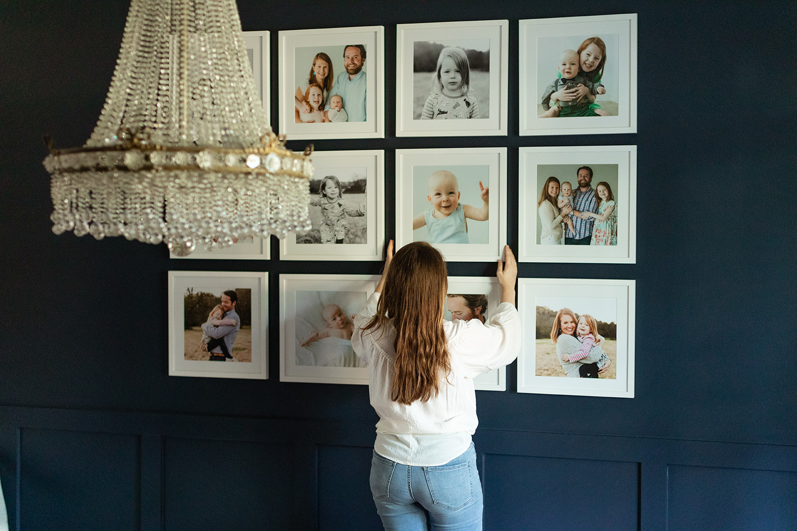sarah sidwell, nashville family photographer hanging up framed photos (gallery wall)