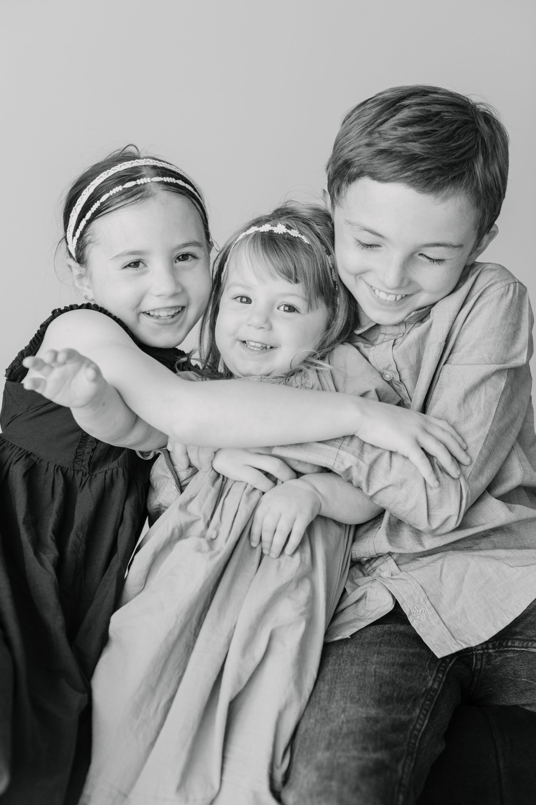 black and white portrait session of three siblings